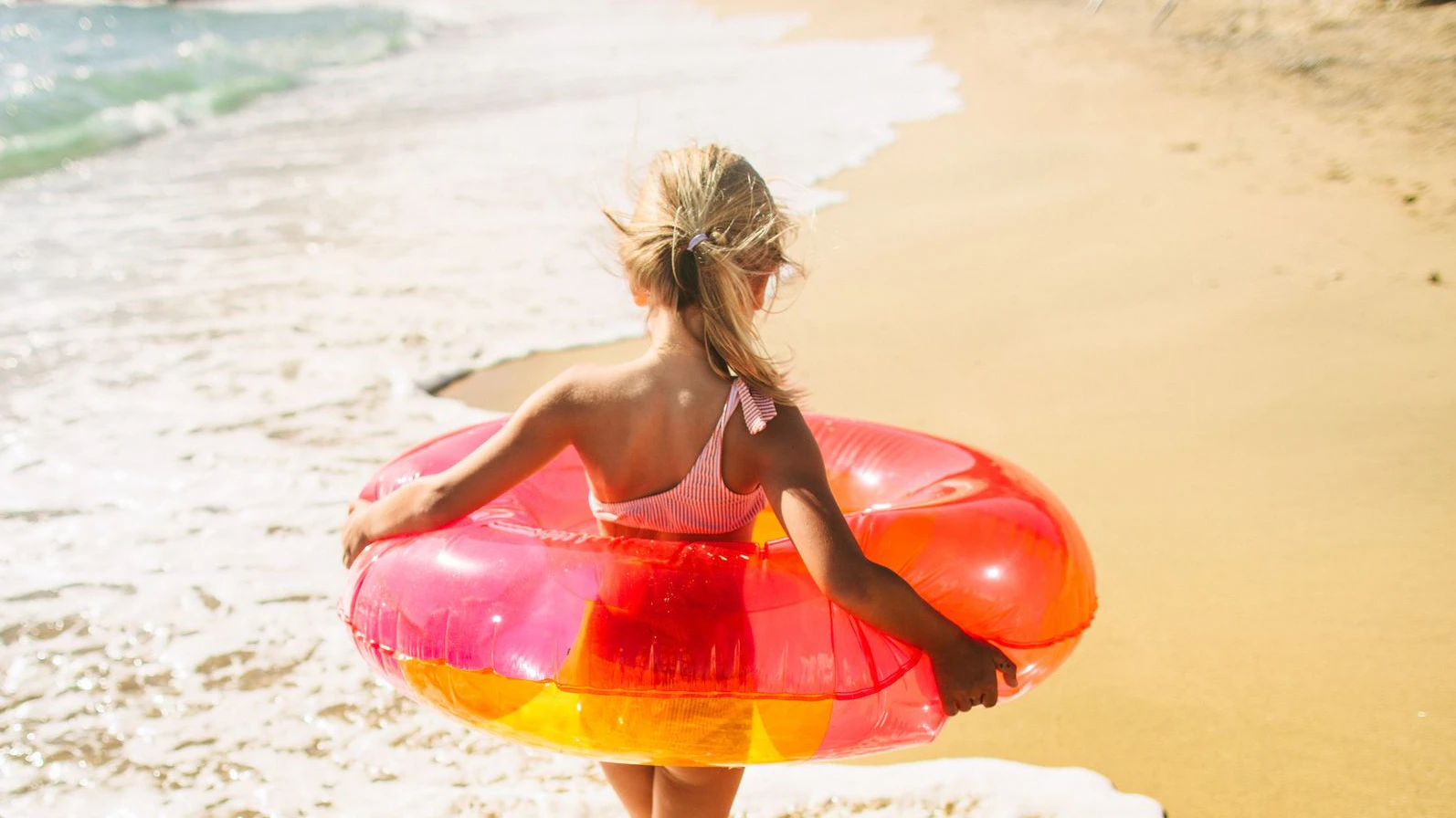 Photo of little girl and her grandma at the beach