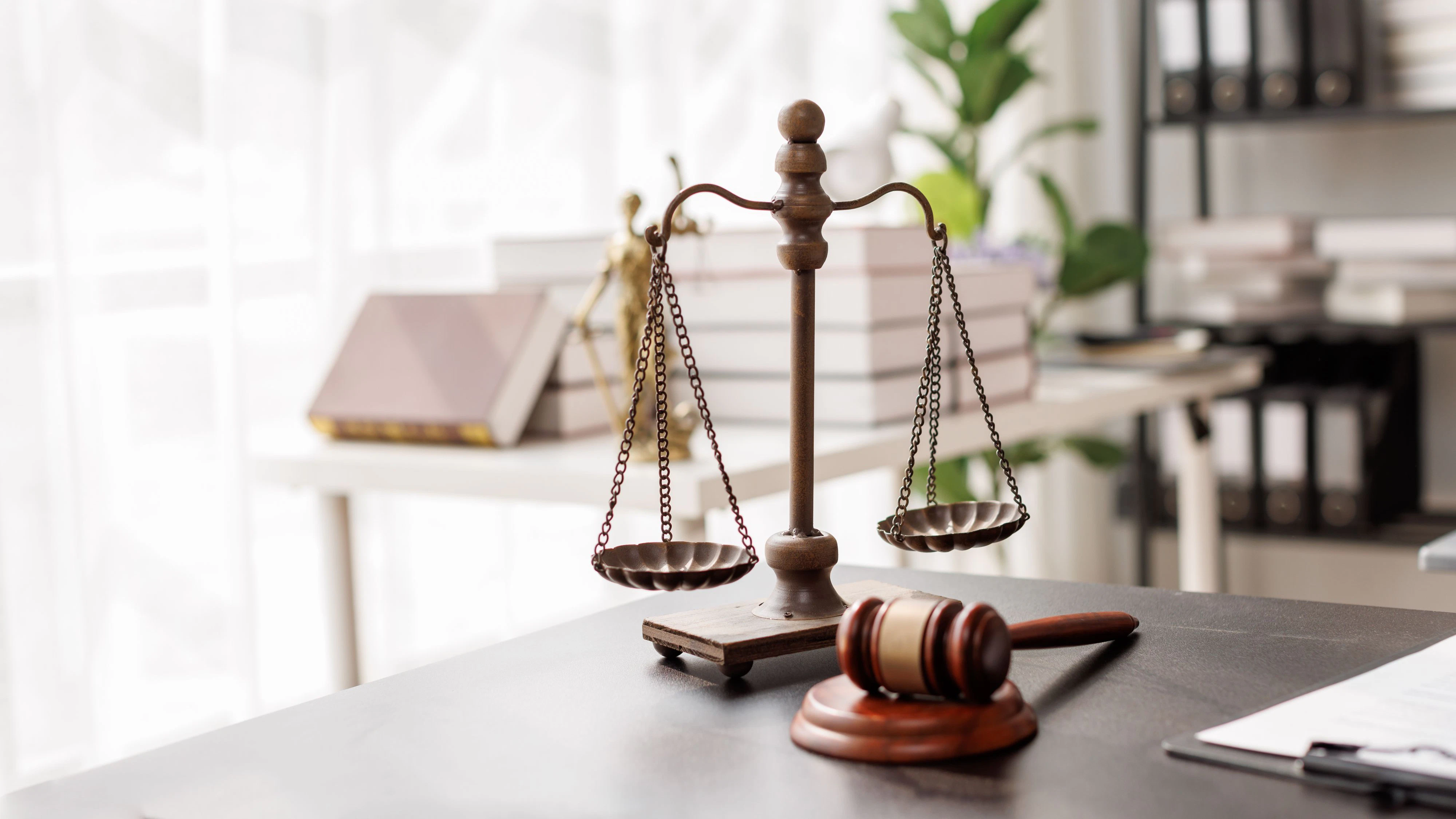 Justice statue, gavel, with LAW Justice lawyers having team meeting at law firm background. Concepts of Law and Legal services.