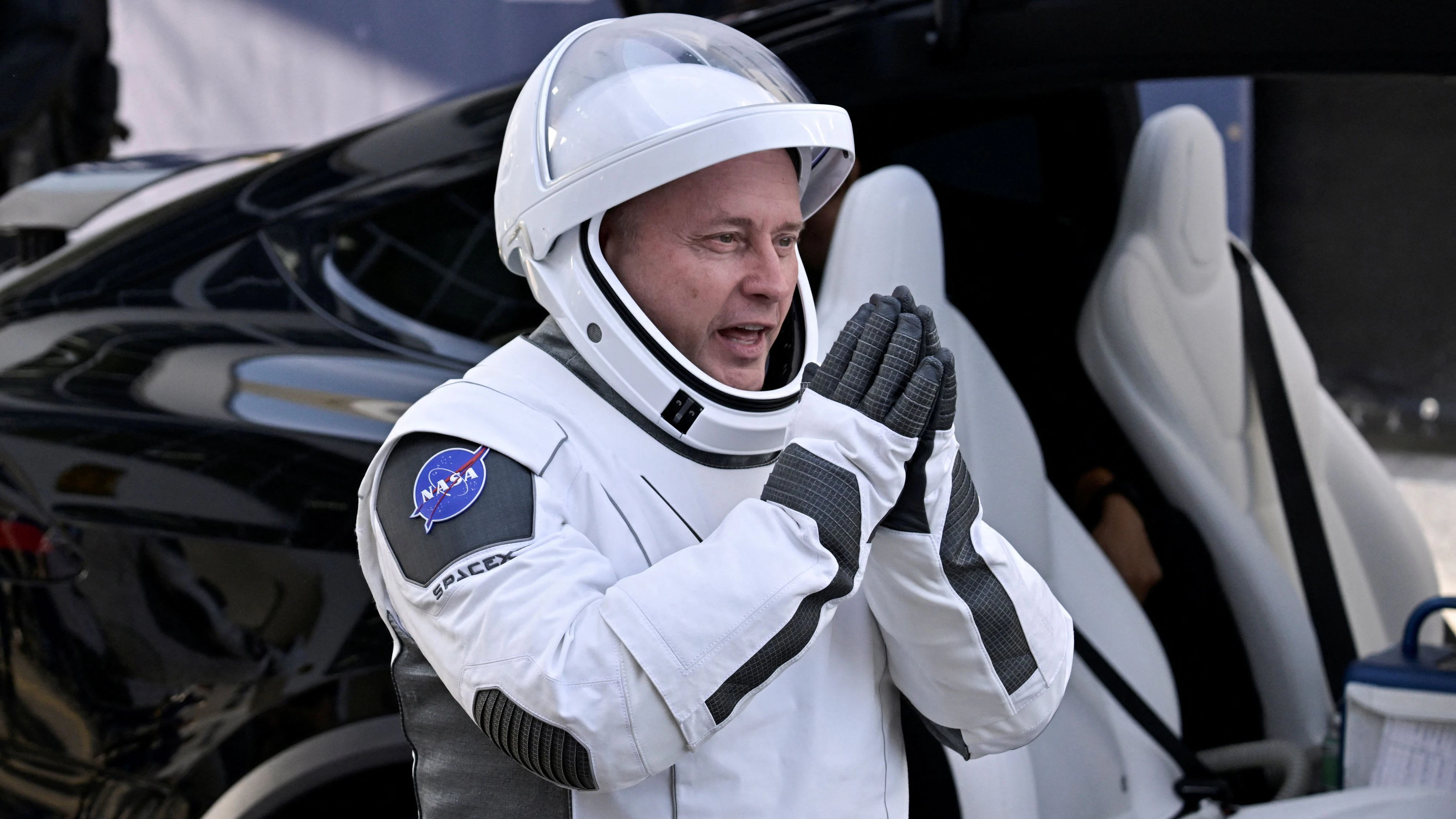 NASA's SpaceX Crew-11 Pilot Mike Fincke of U.S. gestures as he walks out of the Operations & Checkout Building at the Kennedy Space Center for transport to Launch Complex 39-A, ahead of their launch to the International Space Station in Cape Canaveral, Florida, U.S., August 1, 2025. REUTERS/Steve Nesius