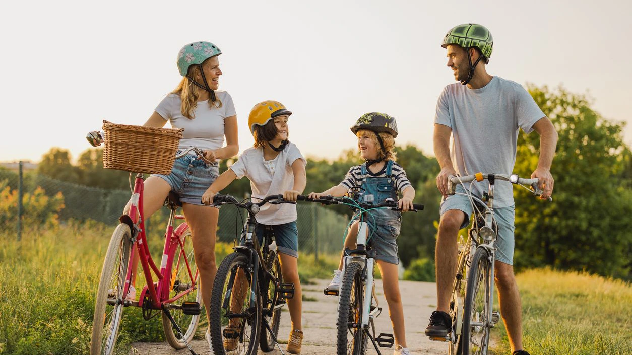 Happy family cycling together in the countryside