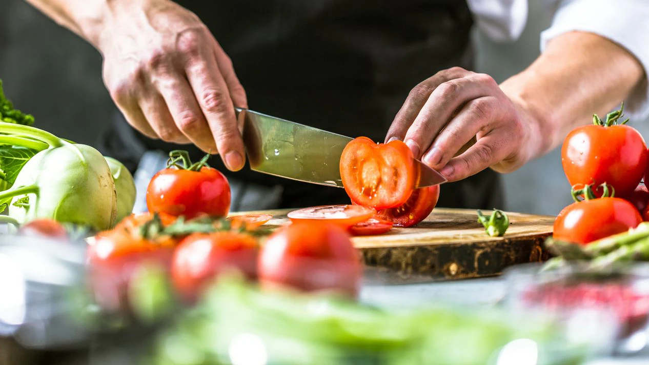 Chef cook preparing vegetables in his kitchen
