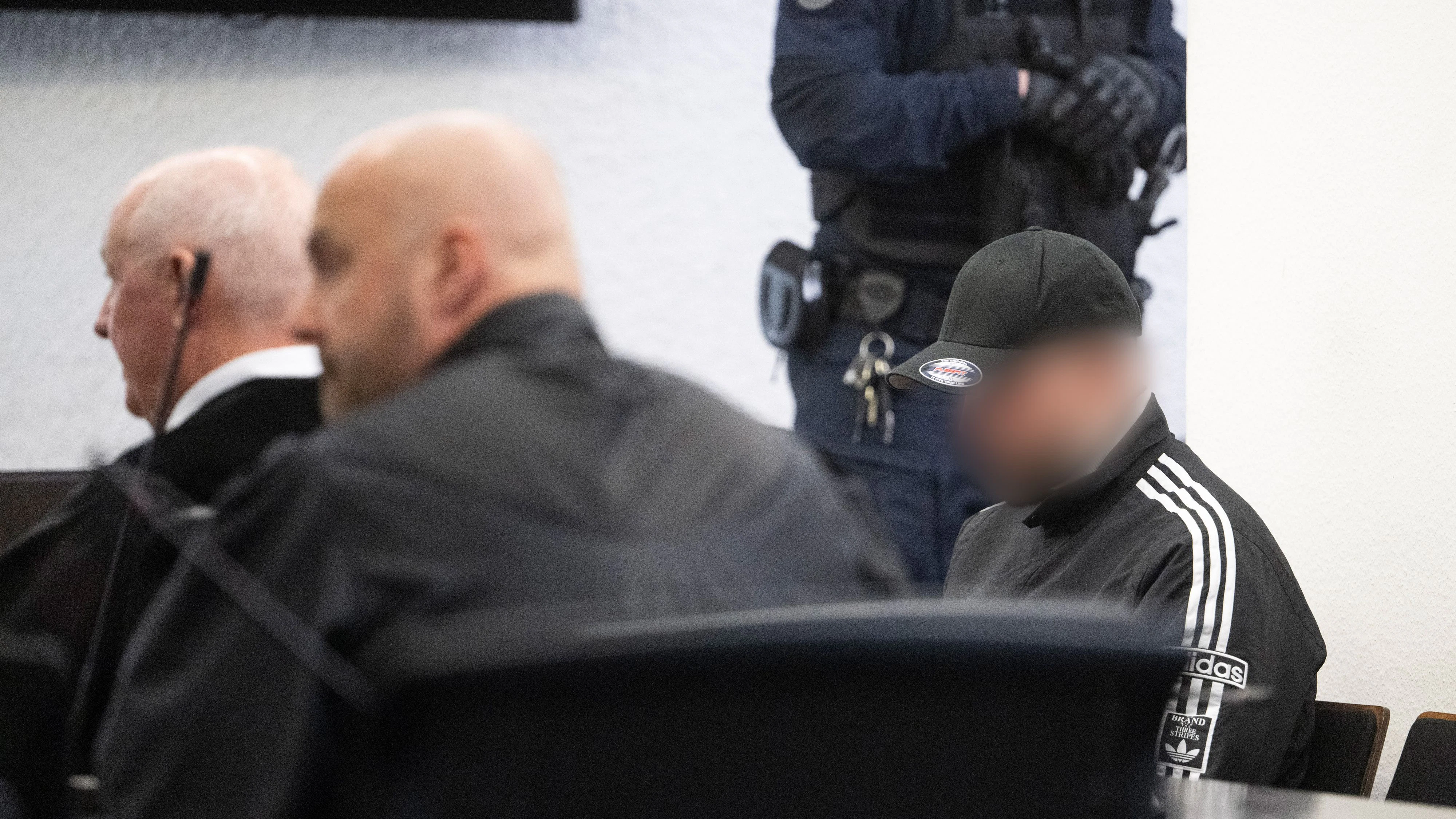 07 April 2026, Baden-Württemberg, Stuttgart: A defendant (r), who was sentenced to life imprisonment for murder for causing an accident, sits in a courtroom of the district court before the verdict is announced in the trial for the murder of two young women. The defendants, aged 32, 34 and 25 at the time of the crime, are said to have arranged to meet in Ludwigsburg a year ago for an illegal "speeding race". Photo: Marijan Murat/dpa - ATTENTION: Person(s) has/have been pixelated by order of the court for legal reasons