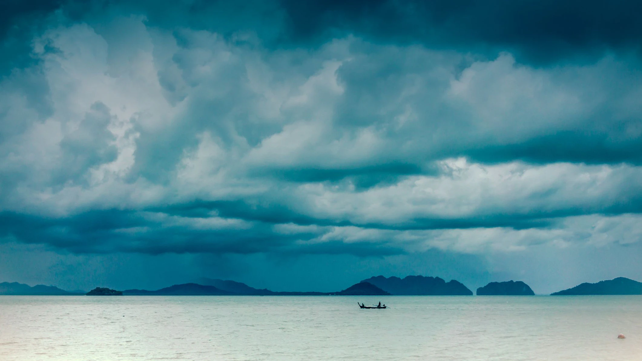 A tropical typhoon moves violently over the Andaman Sea, Krabi, Thailand.  This extreme weather event is rarely photographed due to the dangerous circumstances.  Typhoons, also known as tornado, cyclone or hurricane, are unfortunately becoming more common around the world, due to Global Warming and Climate Change.  These weather patterns are violent and dangerous, often claiming numerous lives in the areas which they occur.