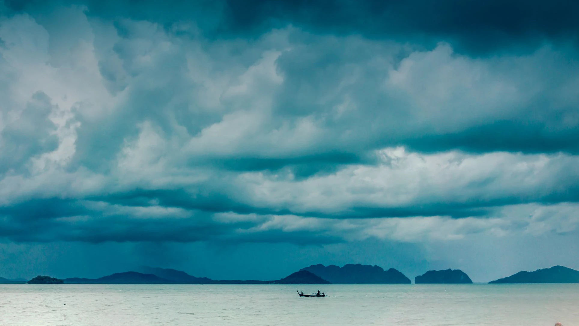 A tropical typhoon moves violently over the Andaman Sea, Krabi, Thailand.  This extreme weather event is rarely photographed due to the dangerous circumstances.  Typhoons, also known as tornado, cyclone or hurricane, are unfortunately becoming more common around the world, due to Global Warming and Climate Change.  These weather patterns are violent and dangerous, often claiming numerous lives in the areas which they occur.