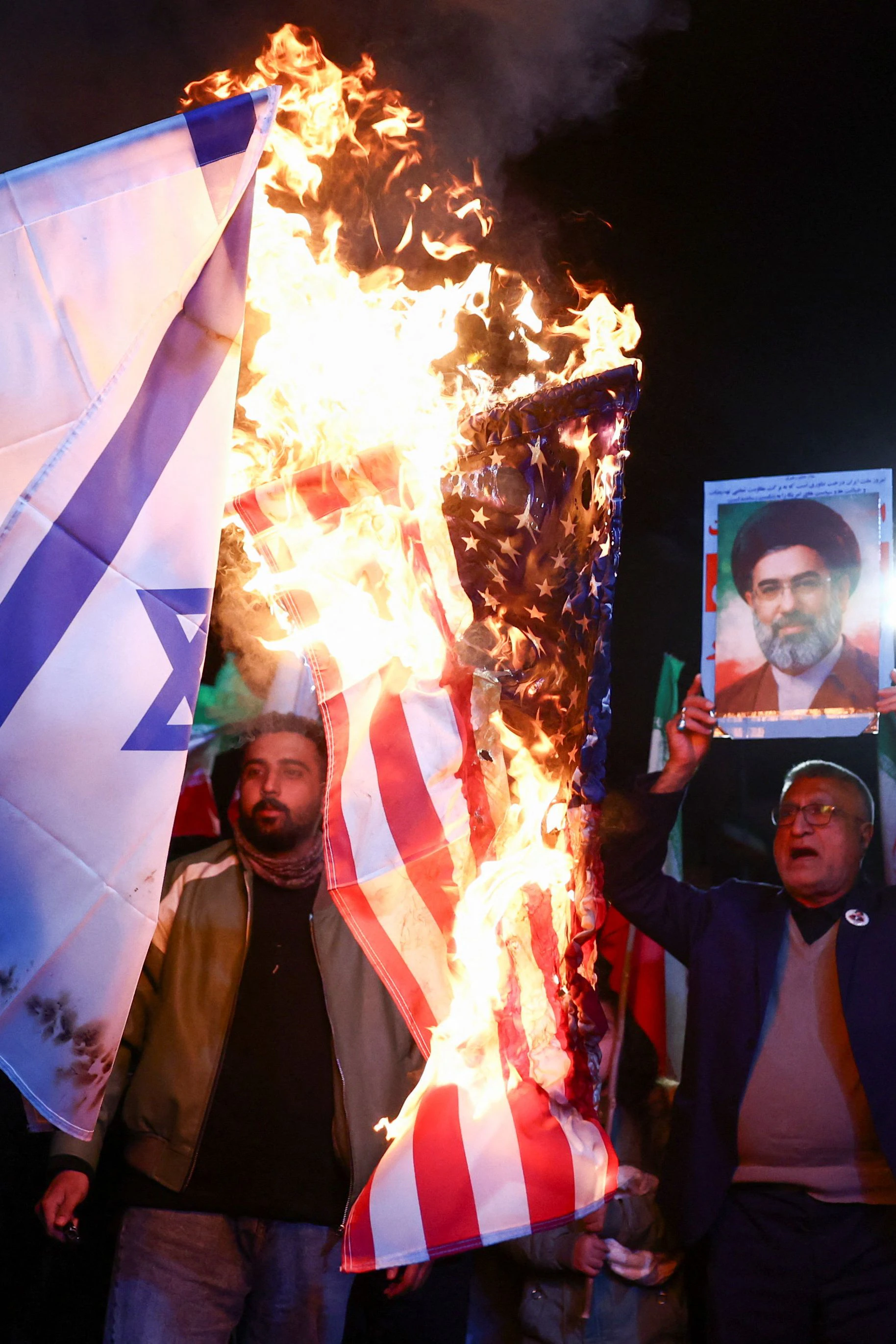 In den Straßen von Teheran werden Fahnen von Israel und der USA verbrannt