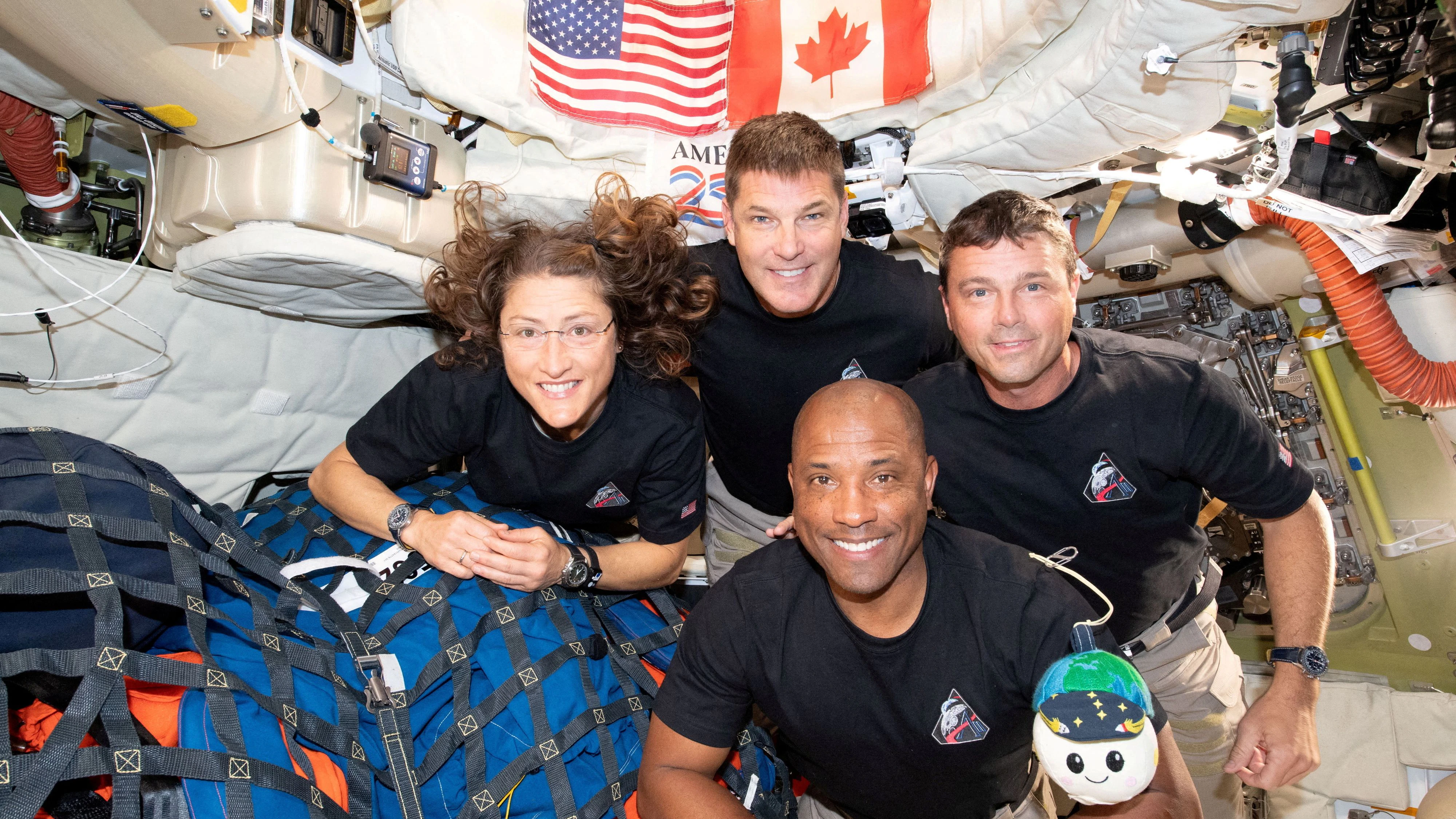 The NASA Artemis II crew, Mission Specialist Christina Koch, Mission Specialist Jeremy Hansen, Commander Reid Wiseman, and Pilot Victor Glover, pose for a group photo inside the Orion spacecraft on their way home following a flyby of the far side of the Moon on April 6, 2026. NASA/Handout via REUTERS THIS IMAGE HAS BEEN SUPPLIED BY A THIRD PARTY. REFILE - CORRECTING DATE FROM "APRIL 6" TO "APRIL 7".    TPX IMAGES OF THE DAY     