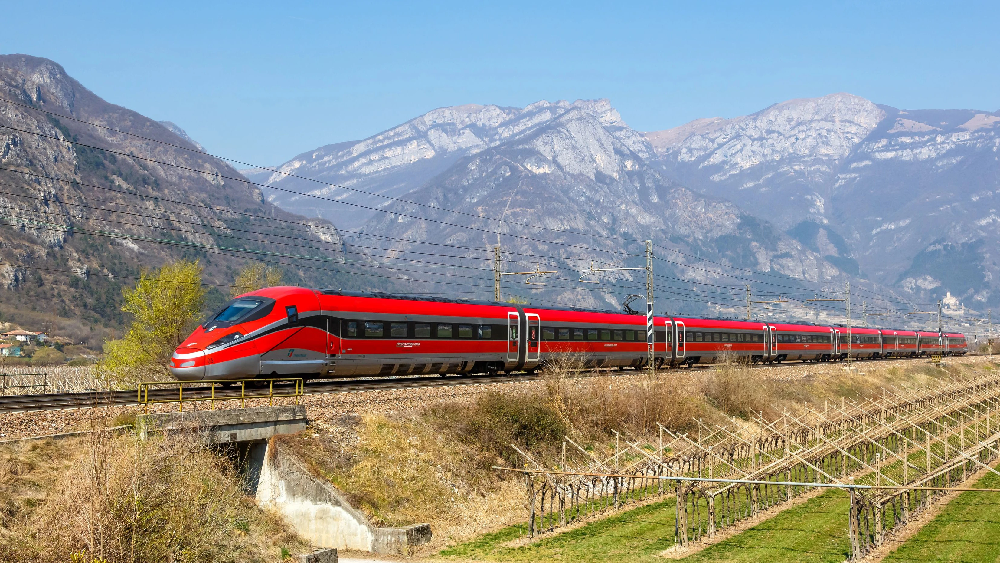 Avio, Italy - March 25, 2022: Frecciarossa FS ETR 1000 high-speed train of Trenitalia on Brenner Railway near Avio, Italy.