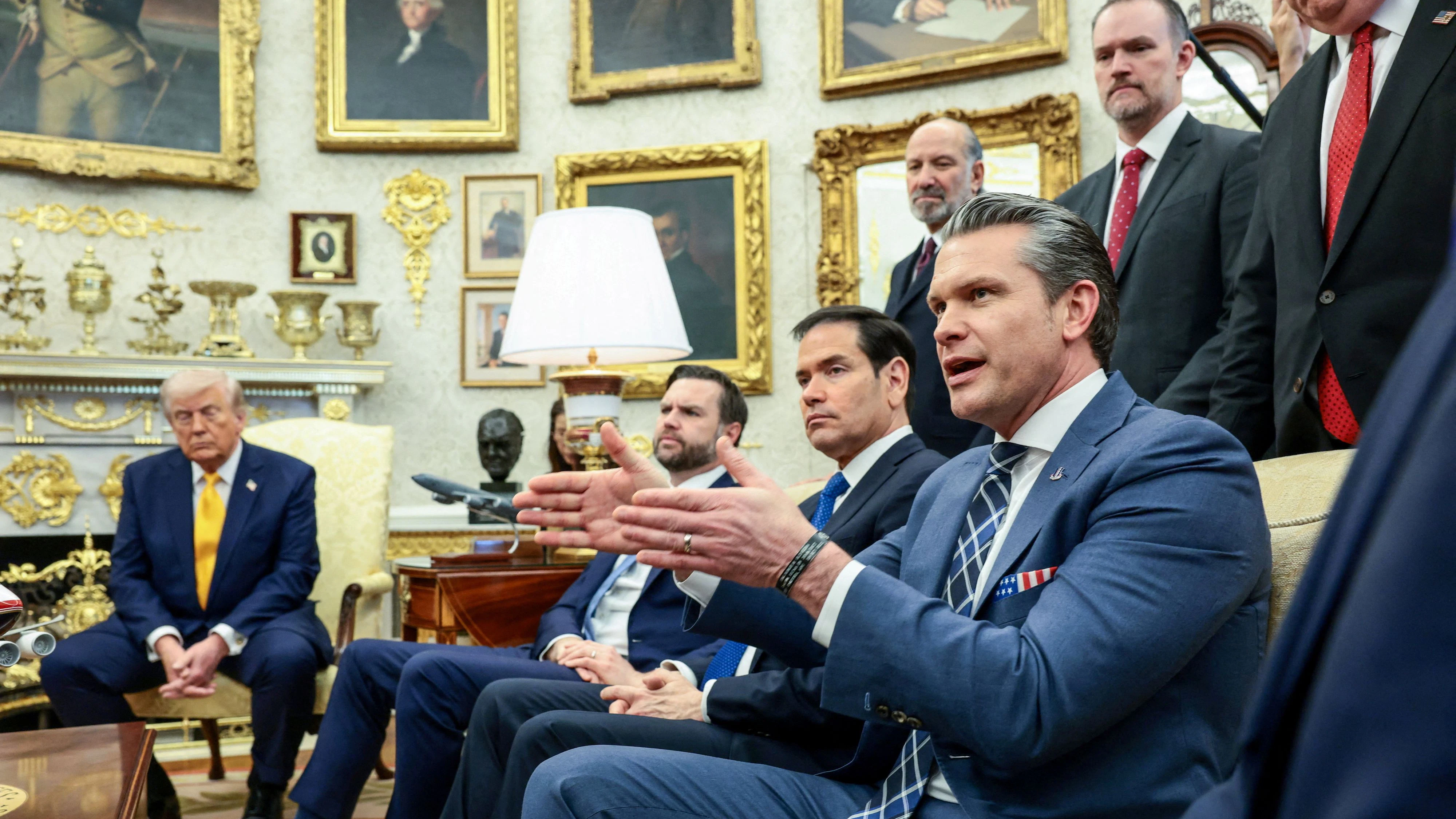 U.S. Defense Secretary Pete Hegseth speaks, with U.S. President Donald Trump, Vice President JD Vance, Secretary of State Marco Rubio, Commerce Secretary Howard Lutnick and Trade Representative Jamieson Greer listening next to him, during a meeting with Japanese Prime Minister Sanae Takaichi (not pictured) in the Oval Office at the White House in Washington, D.C., U.S., March 19, 2026. REUTERS/Evelyn Hockstein