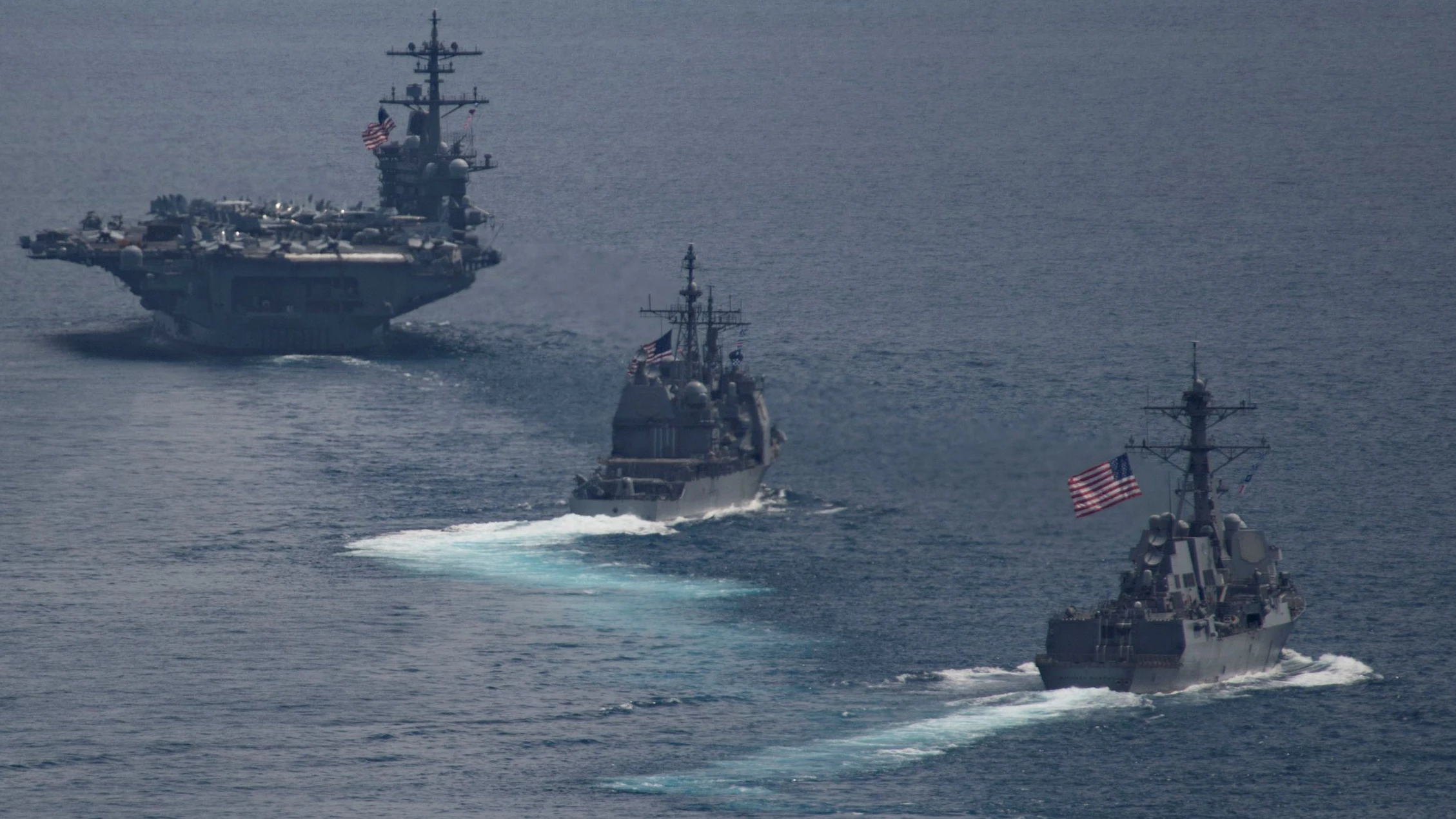 The aircraft carrier USS Carl Vinson (CVN 70), front, leads the Arleigh Burke-class guided-missile destroyer USS Michael Murphy (DDG 112 and the Ticonderoga-class guided-missile cruiser USS Lake Champlain (CG 57), in the Indian ocean April 14, 2017. Photo taken April 14, 2017.   U.S. Navy photo by Mass Communication Specialist 3rd Class Danny Kelley/Handout via REUTERS ATTENTION EDITORS - THIS IMAGE WAS PROVIDED BY A THIRD PARTY. EDITORIAL USE ONLY.