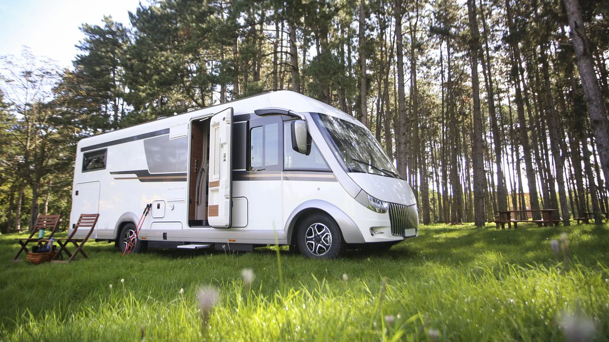 Recreational vehicle (motor home) in a mountain forest.