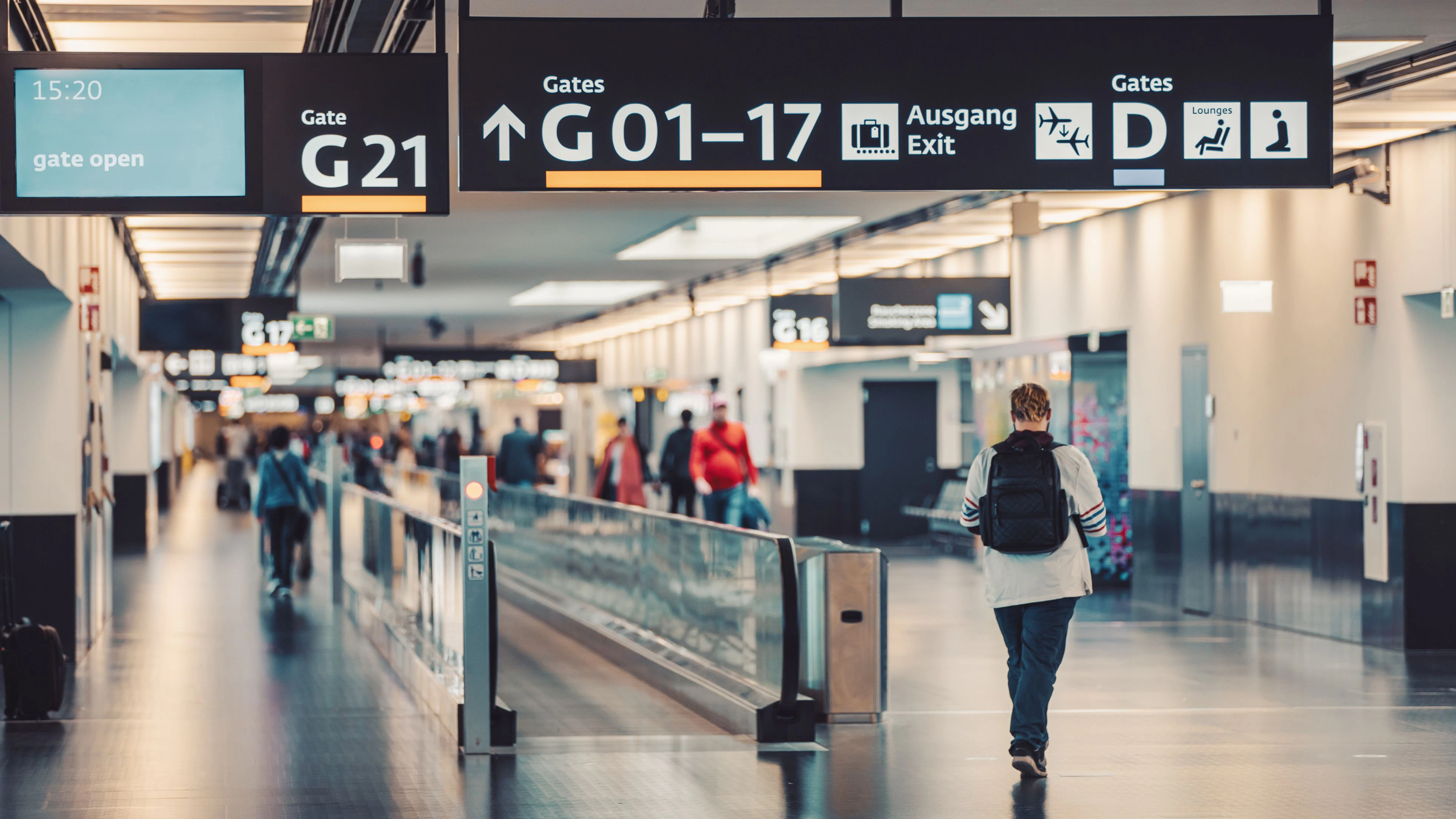 Peoples walking and carries luggage in Vienna airport terminal