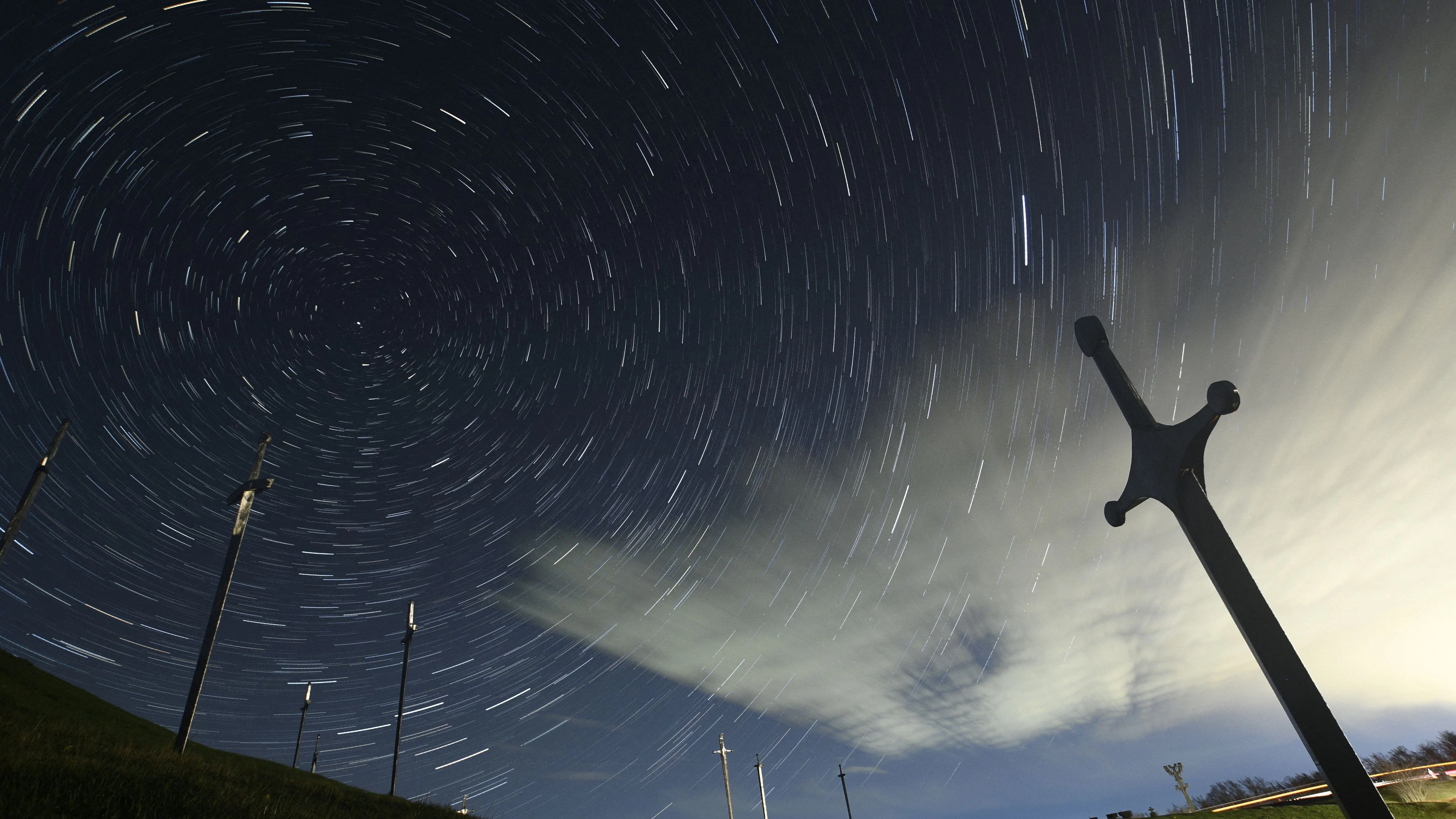 A view shows stars and meteor trails in the night sky above the Battle of Didgori memorial complex during the Lyrid meteor shower in Didgori, Georgia, April 22, 2023, in this composite image of 14 separate photographs. REUTERS/Irakli Gedenidze