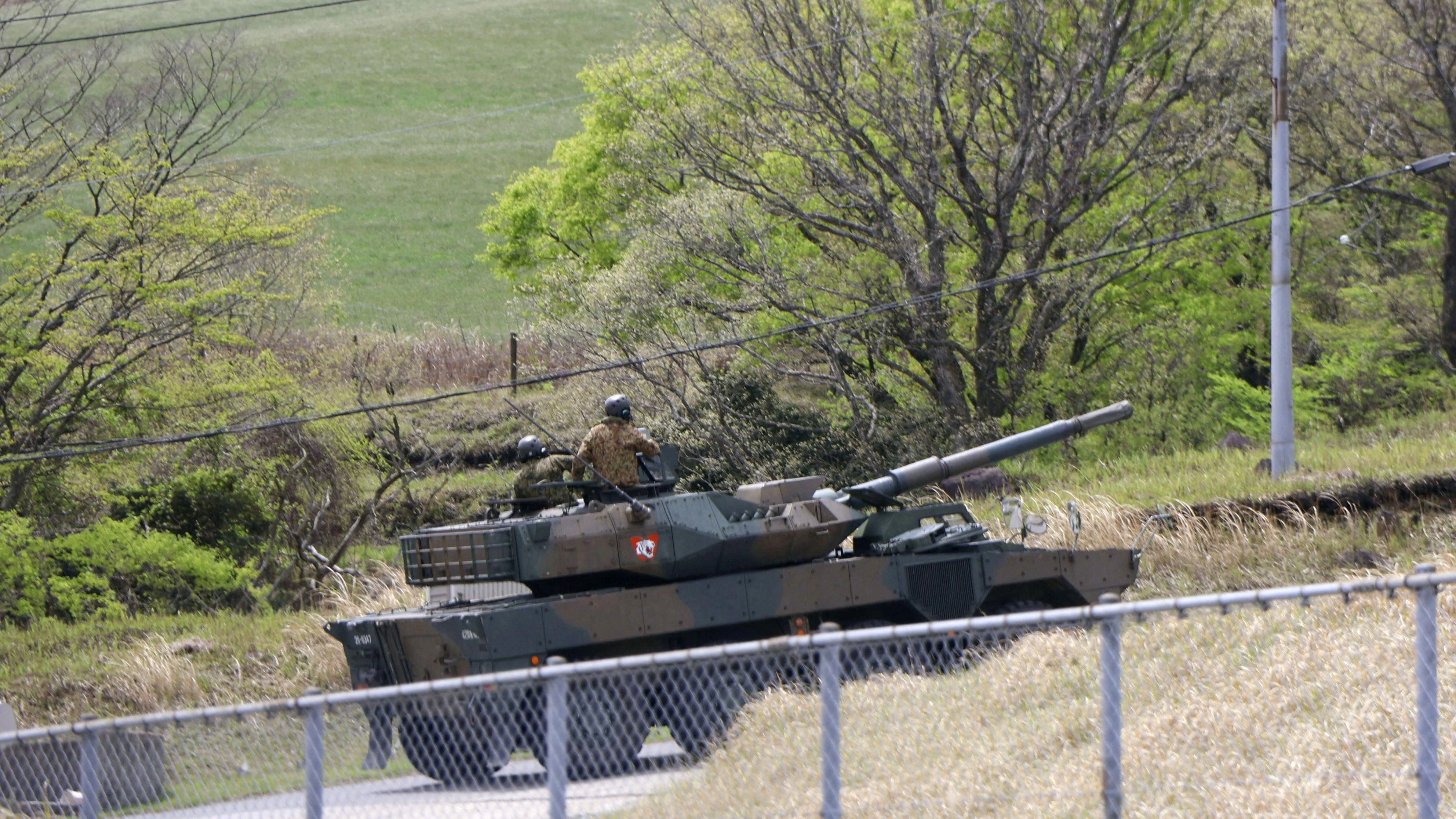 A military vehicle runs at the Japanese Ground Self-Defense Force's (JGSDF) Hijudai maneuver area after a tank exploded and multiple JGSDF members died during their military training in Oita Prefecture, southwestern Japan April 21, 2026, in this photo taken by Kyodo. Mandatory credit Kyodo/via REUTERS ATTENTION EDITORS - THIS IMAGE HAS BEEN SUPPLIED BY A THIRD PARTY. MANDATORY CREDIT. JAPAN OUT. NO COMMERCIAL OR EDITORIAL SALES IN JAPAN.