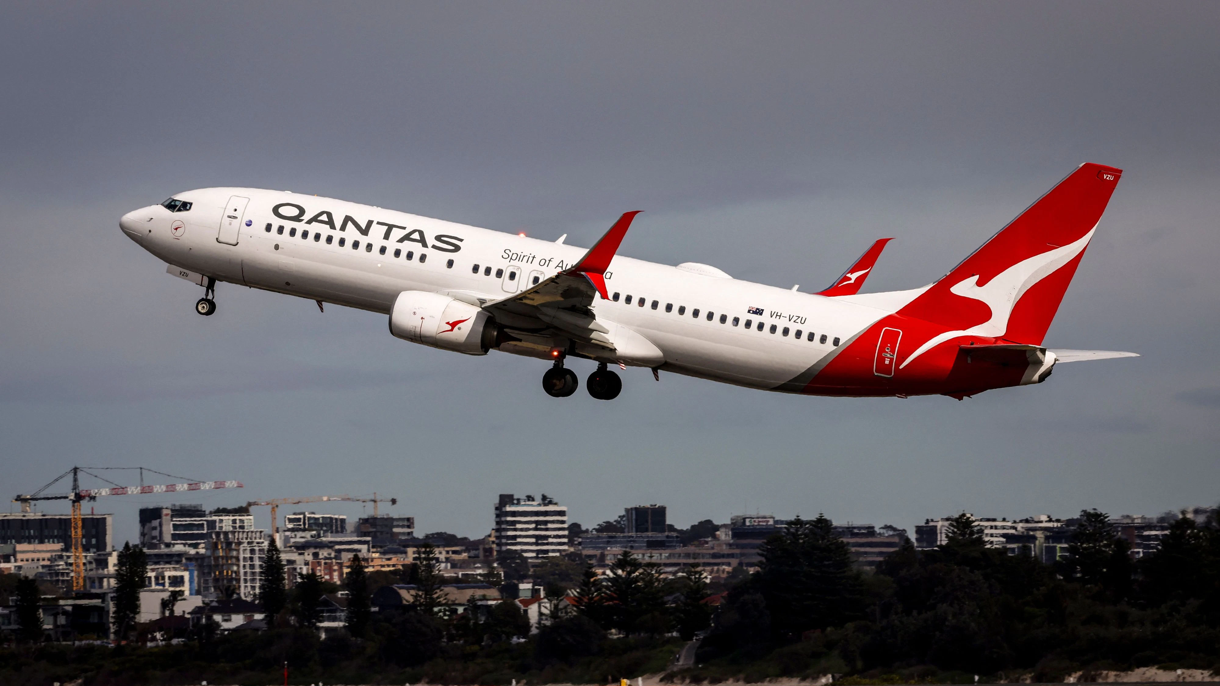 (FILES) A Qantas Airways Boeing 737 aircraft takes off from Sydney International Airport in Sydney on August 18, 2025. Surging jet fuel prices may raise costs for Australia's Qantas by up to Aus$800 million (US$570 million) in the second half of this year, the airline said April 14, 2026. War in the Middle East has led jet fuel prices to more than double, and they remain "extremely volatile", the carrier said in a market update. (Photo by DAVID GRAY / AFP)