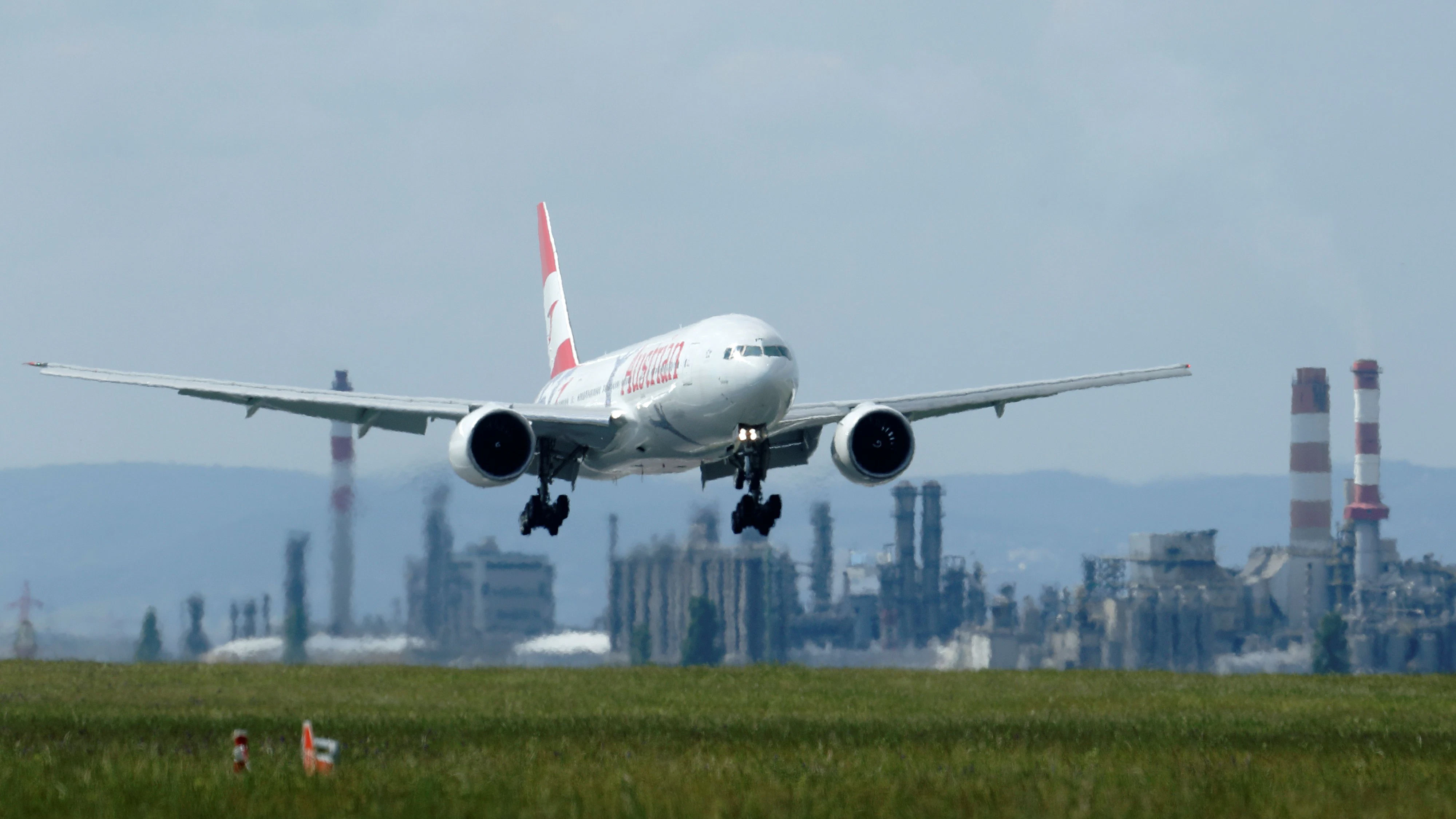 A Boeing 777-2Q8/ER branded with Austrian's new corporate design flies past OMV's refinery as it approaches Vienna's airport in Schwechat, Austria, May 8, 2018. REUTERS/Heinz-Peter Bader