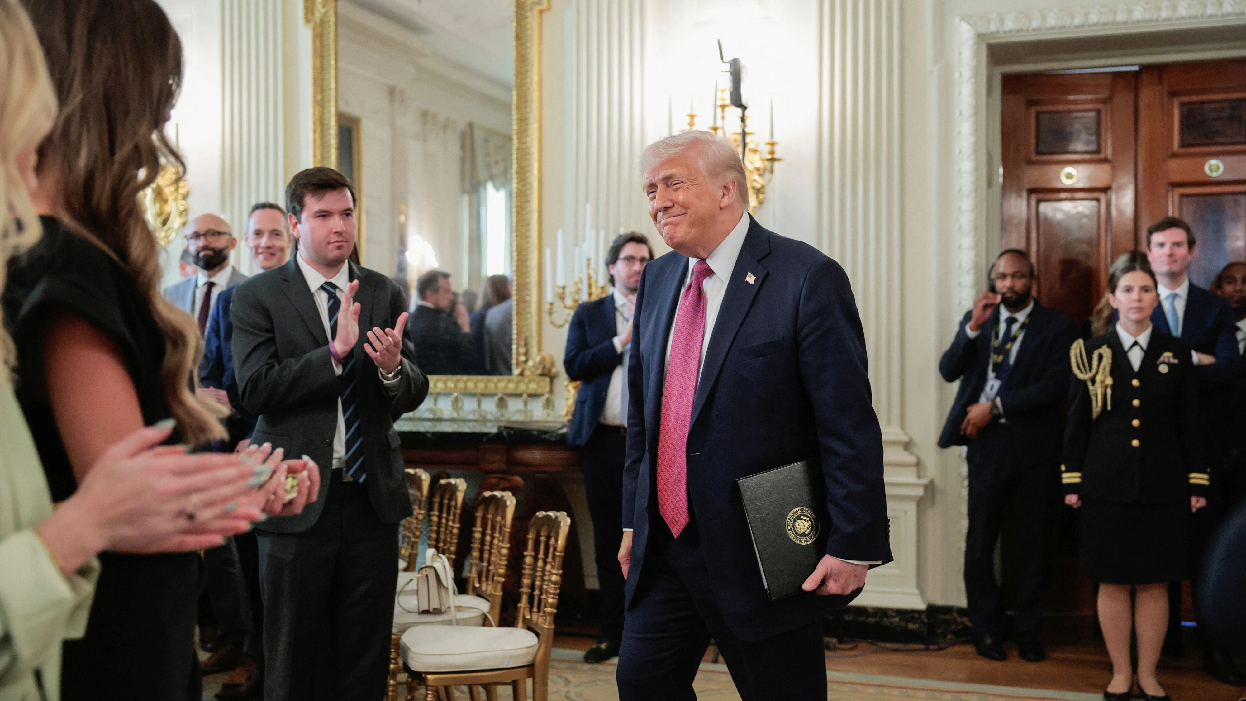 U.S. President Donald Trump attends an event to delivers remarks to NCAA Collegiate National Champions in the State Dining Room at the White House in Washington, D.C., U.S., April 21, 2026. REUTERS/Kylie Cooper