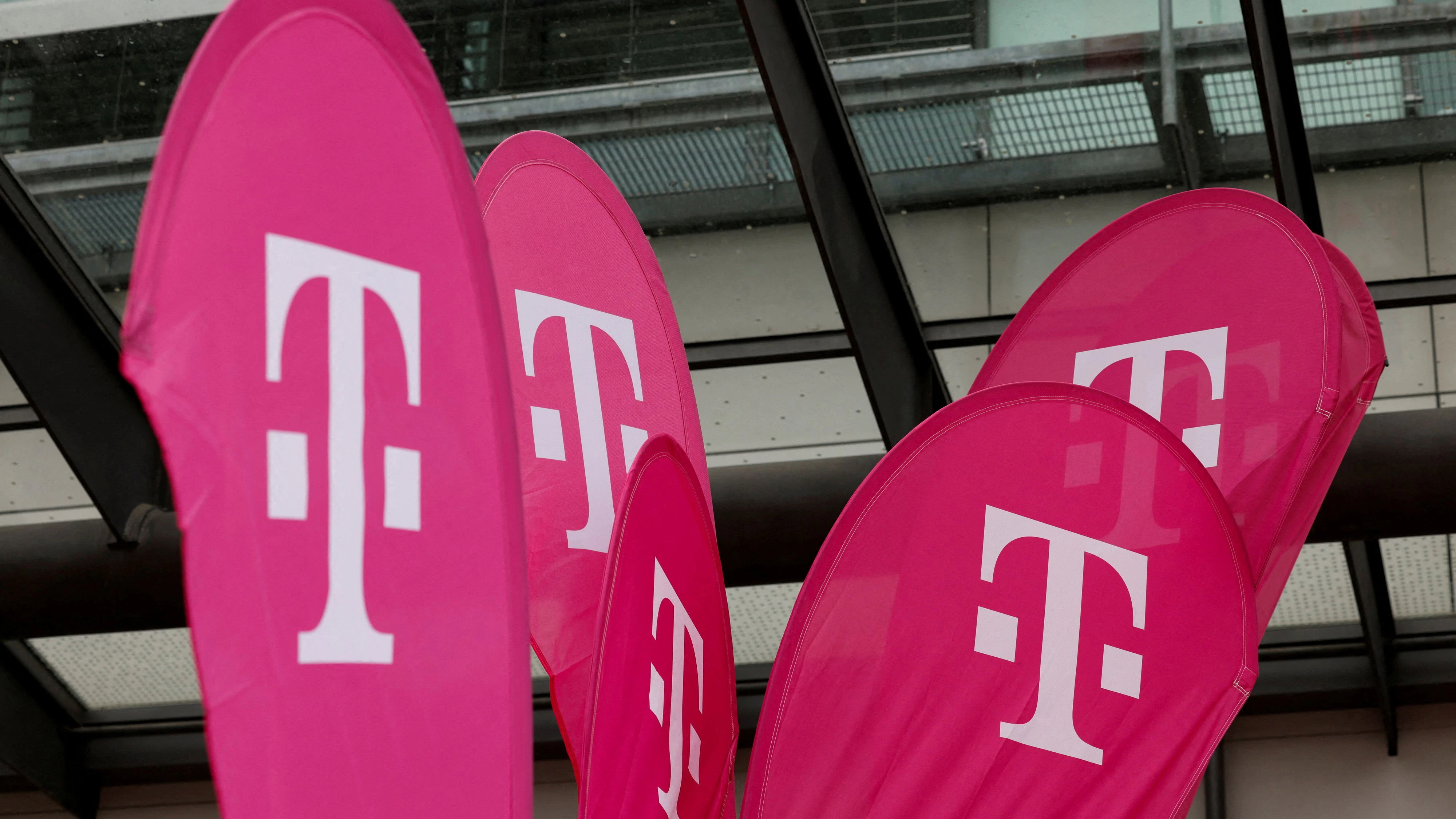FILE PHOTO: Logo of German telecommunication giant Deutsche Telekom is displayed before the official news conference about the opening of the AI Cloud centre in Munich, Germany, February 4, 2026. REUTERS/Michaela Stache/File Photo