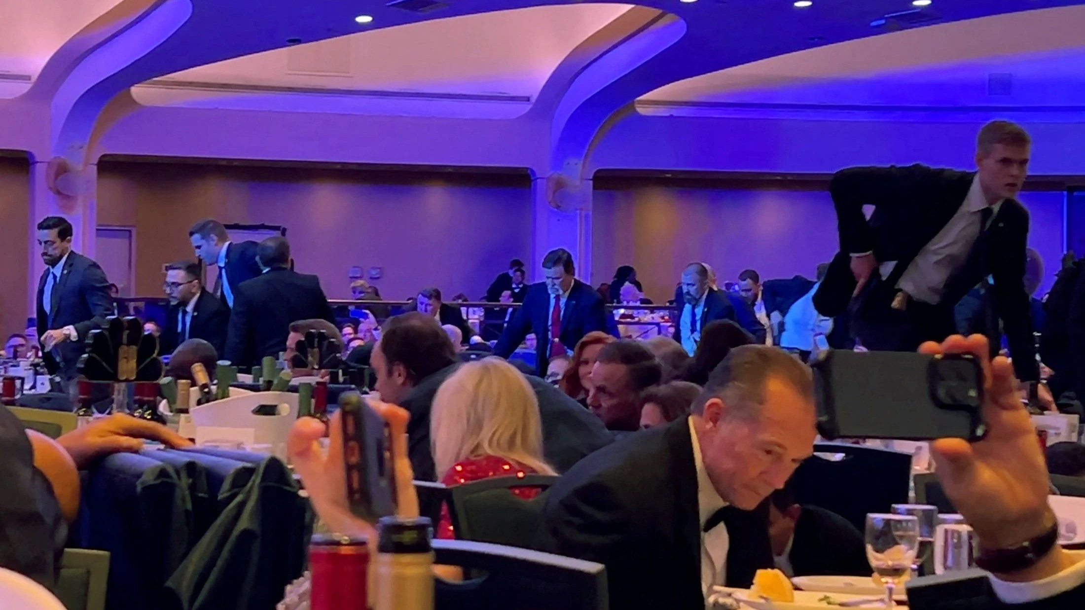 Secret Service agents enter the room to evacuate cabinet members, shortly after U.S. President Donald Trump was escorted out, after a man opened fire with a shotgun on security personnel outside the room during the annual White House Correspondents' Association dinner in Washington, D.C., U.S., April 25, 2026, in this screengrab from a video. REUTERS/Bo Erickson  