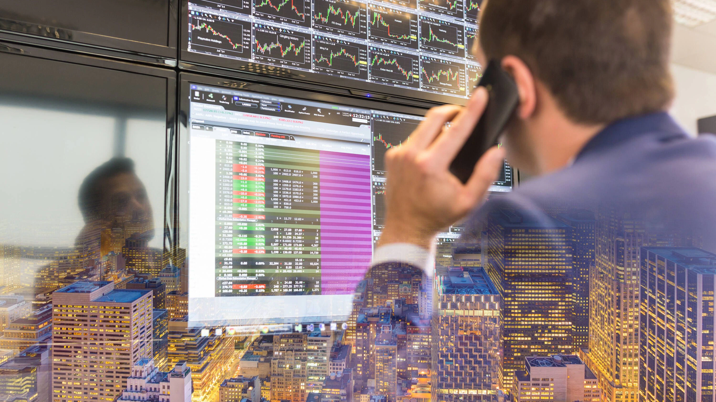Stock trader looking at computer screens. Businessman with cell phone trading stocks. Stock analyst looking at graphs, indexes and numbers on multiple computer screens. New Your city lights reflection in glass., model releasedbusinessman, broker, trader, business, stock, market, finance, trading, exchange, man, computer, office, economy, people, technology, investment, dealing, financial, chart, graph, corporate, communication, information, growth, professional, screen, money, analyzing, global, manager, capital, commerce, person, management, investor, strategy, data, entrepreneur, numbers, index, cell phone, phone, mobile phone, bank, work, city, New York, lights, reflection, trade, PUBLICATIONxINxGERxSUIxAUTxONLY