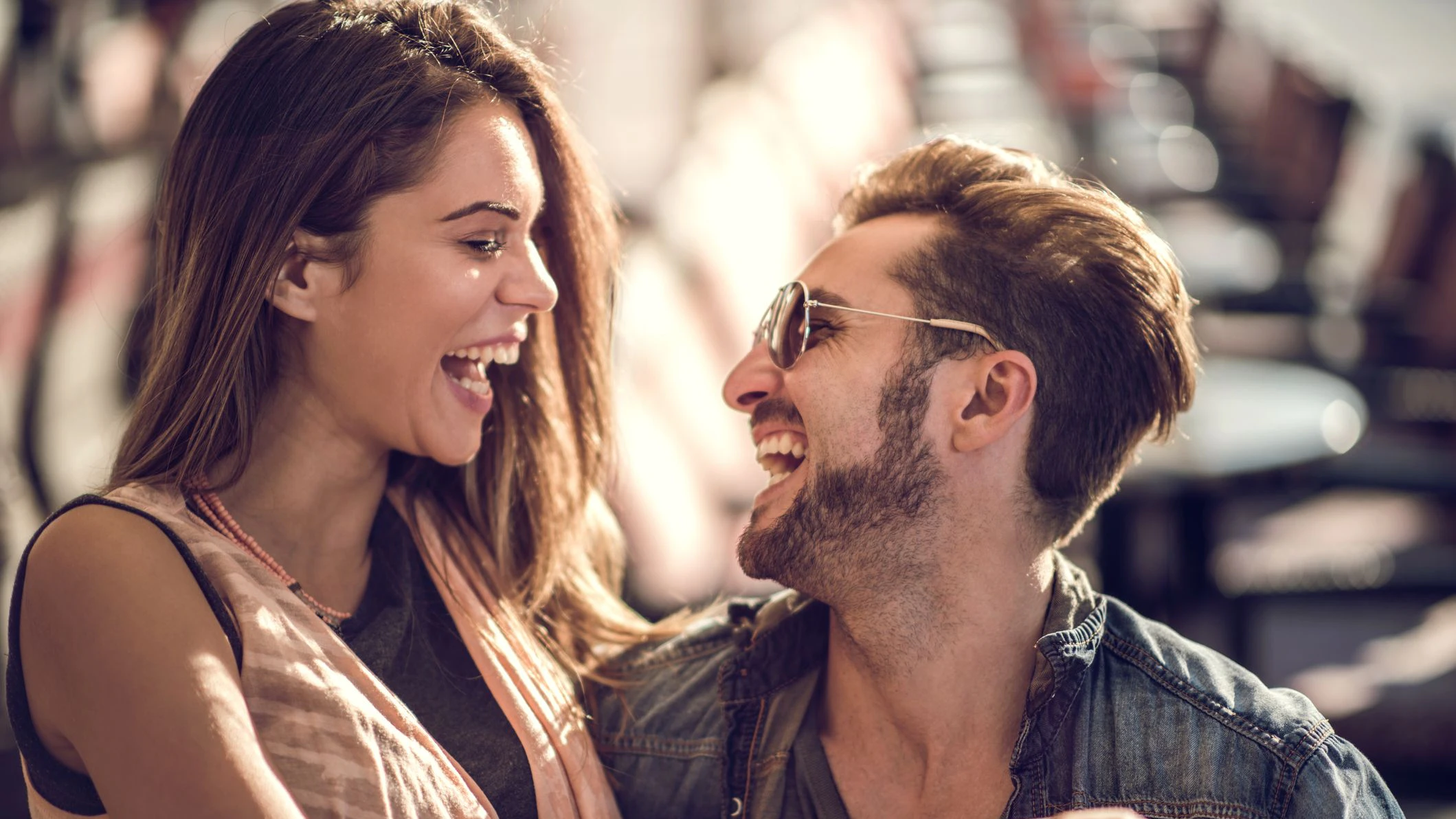 Young couple spending their time together in a cafe and laughing.