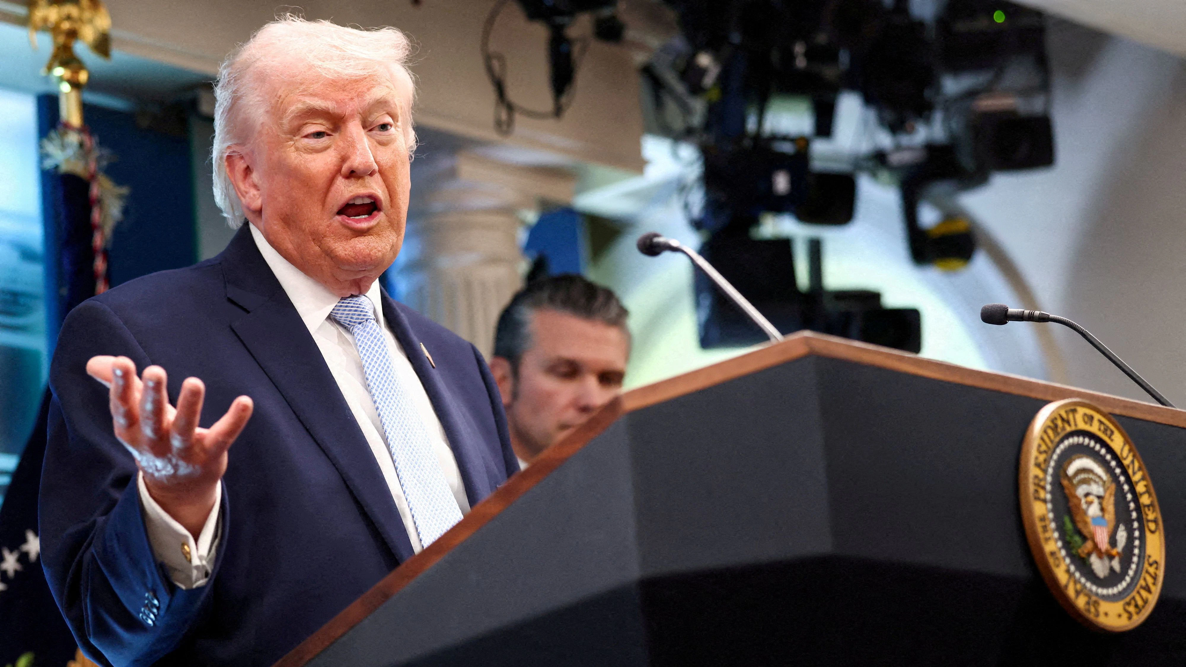 FILE PHOTO: U.S. President Donald Trump, flanked by Secretary of Defense Pete Hegseth, speaks during a press conference in the James S. Brady Press Briefing Room at the White House in Washington, D.C., U.S., April 6, 2026. REUTERS/Kevin Lamarque/File Photo