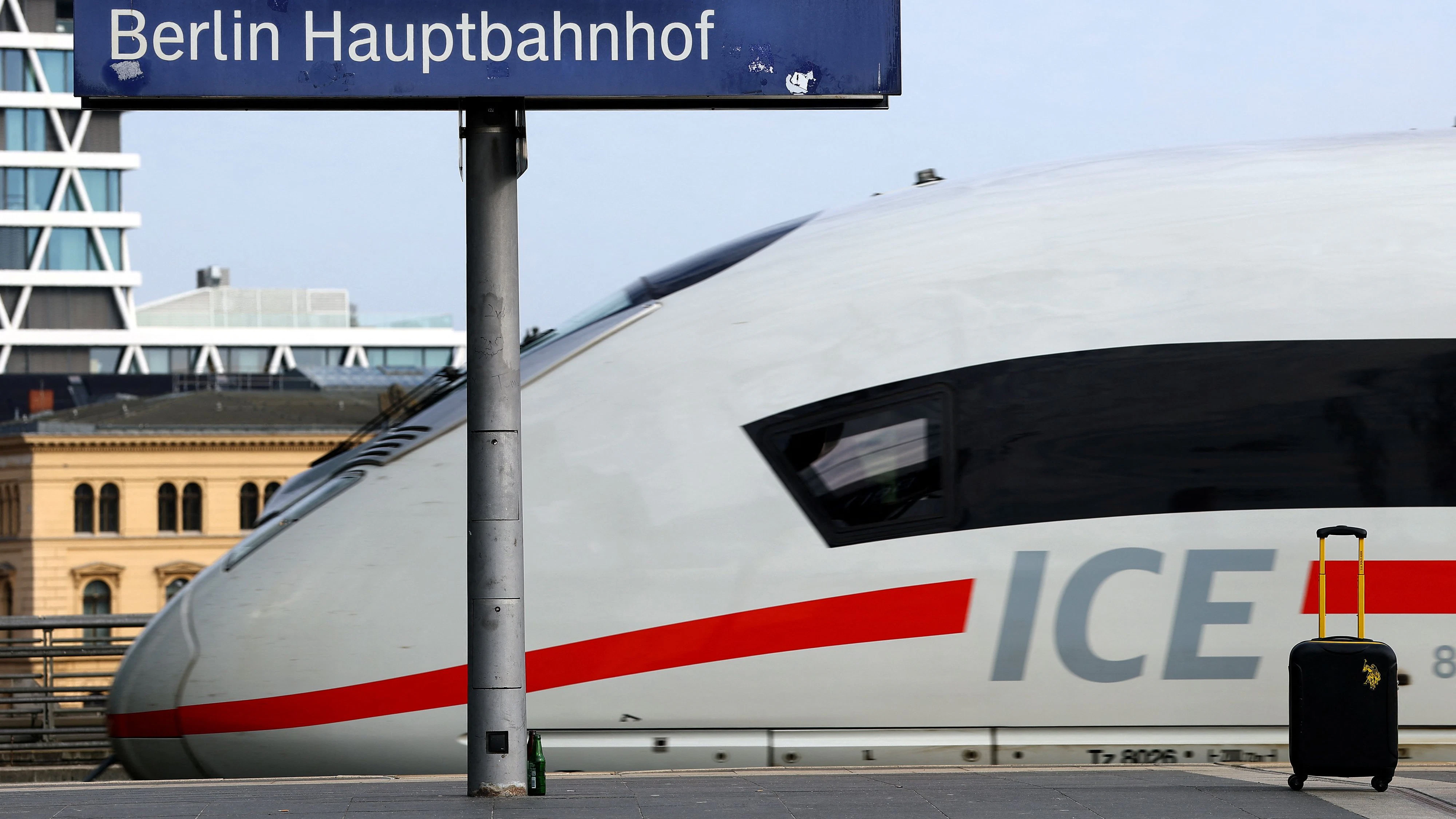 A trolley bag stands on a platform at Berlin's main train station as a Deutsche Bahn ICE train arrives ahead of the Easter holidays, in Berlin, Germany, April 2, 2026. REUTERS/Lisi Niesner