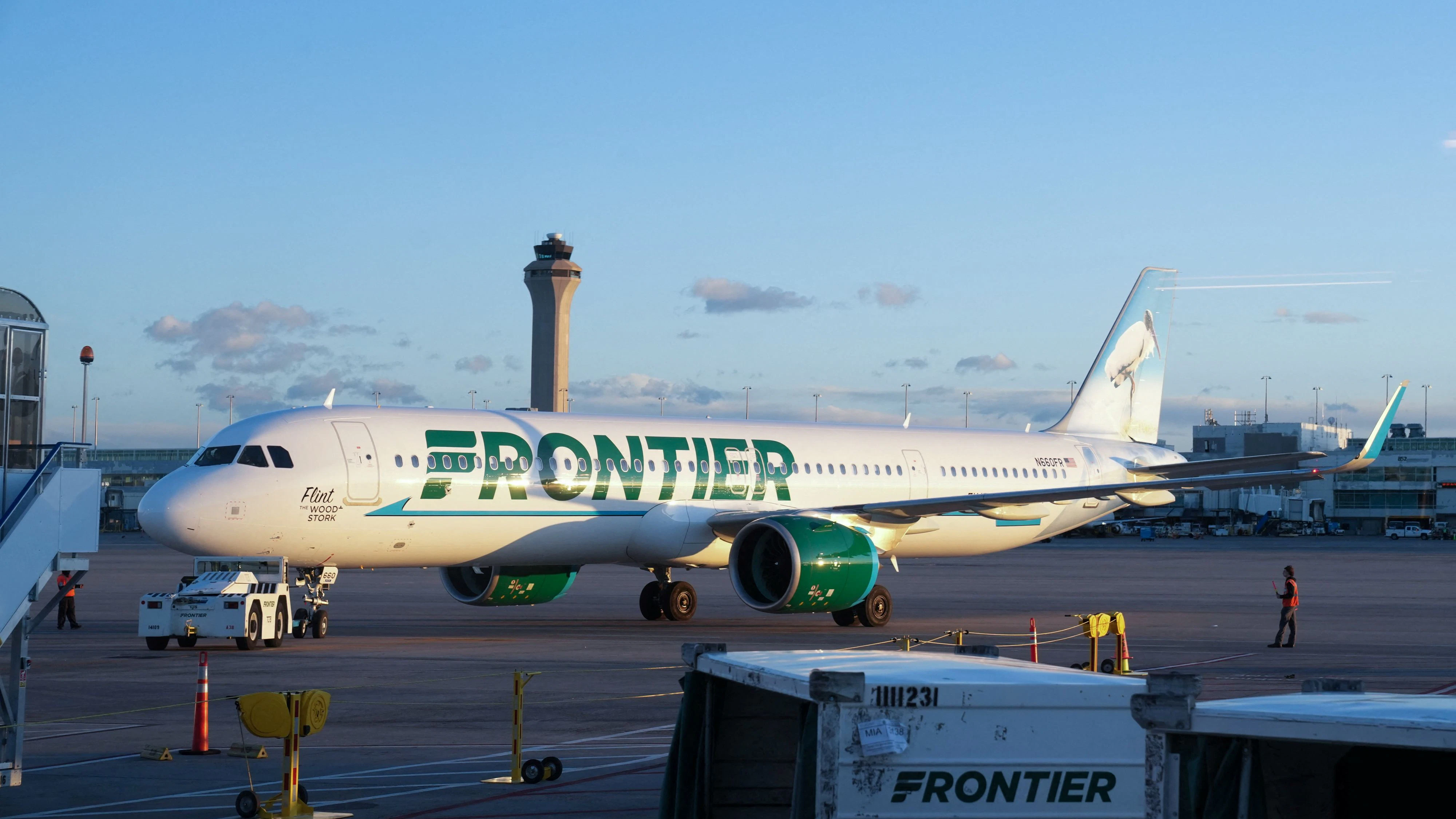 The air traffic control tower is seen as a Frontier flight pulls away from the gate at the Denver International Airport terminal, in Denver, Colorado, U.S., May 15, 2025.  REUTERS/Megan Varner