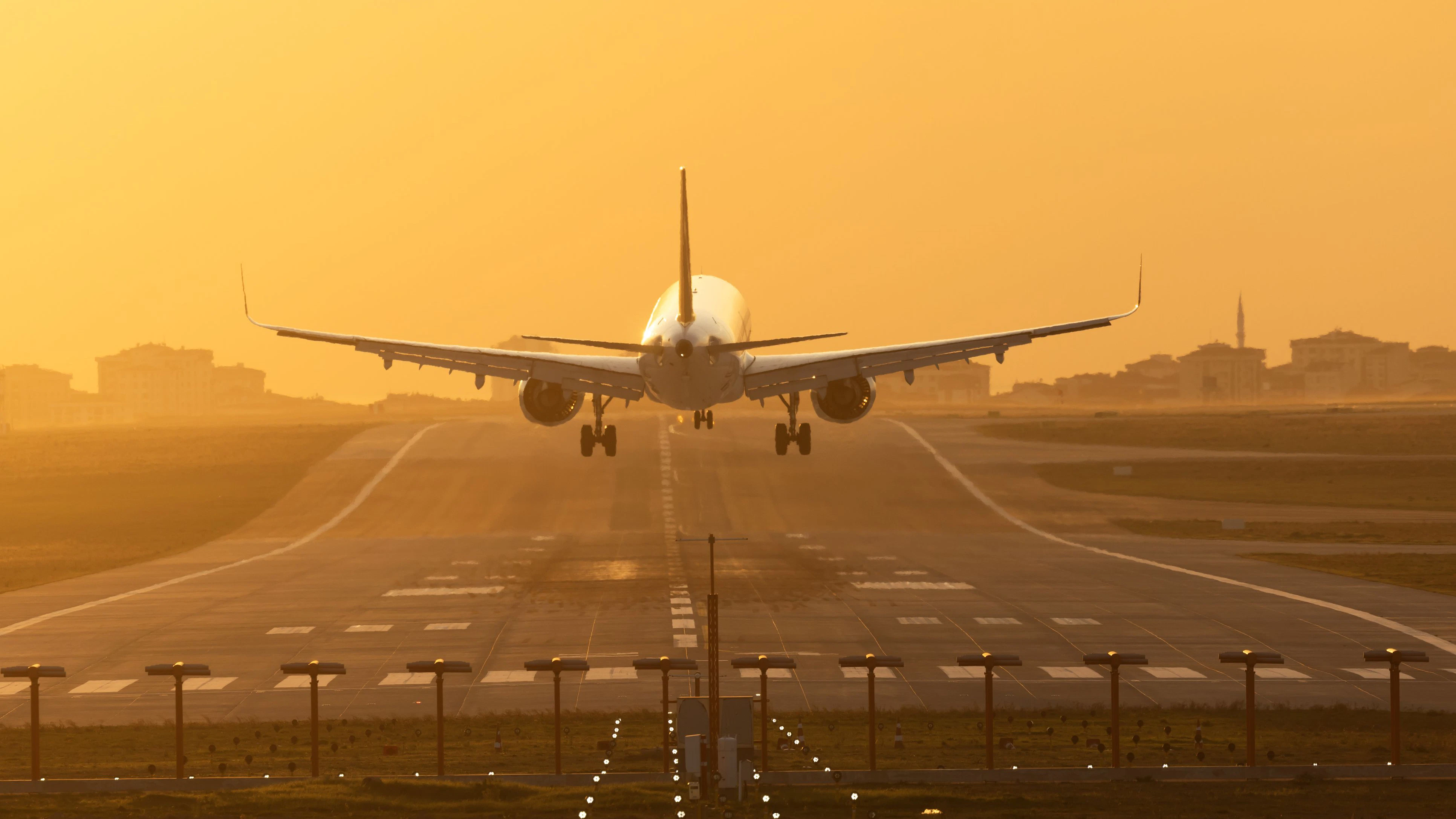Passenger airplane landing at dusk
