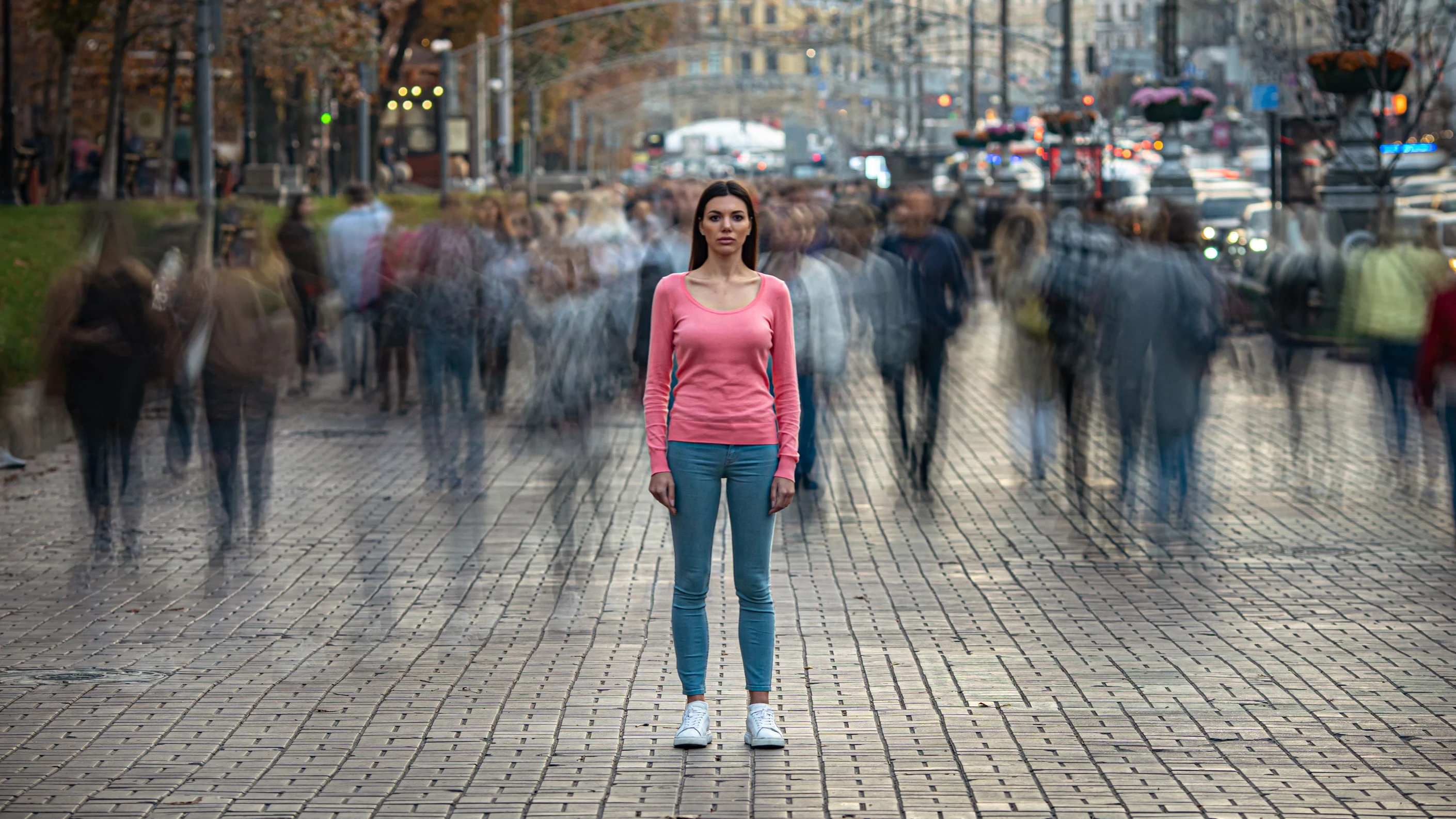 The young girl stands on the crowded urban street