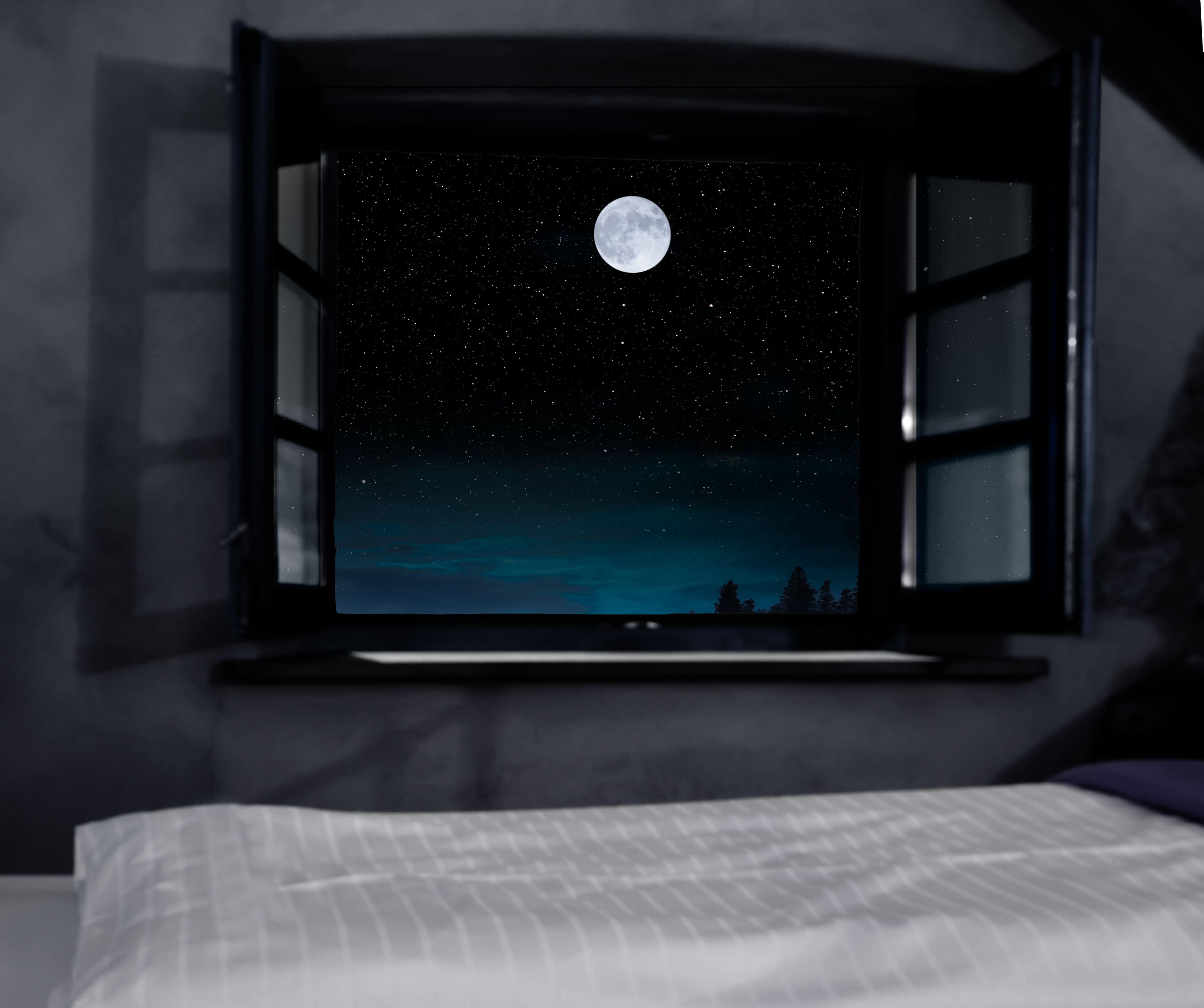 Open window with view to starry sky with full moon
