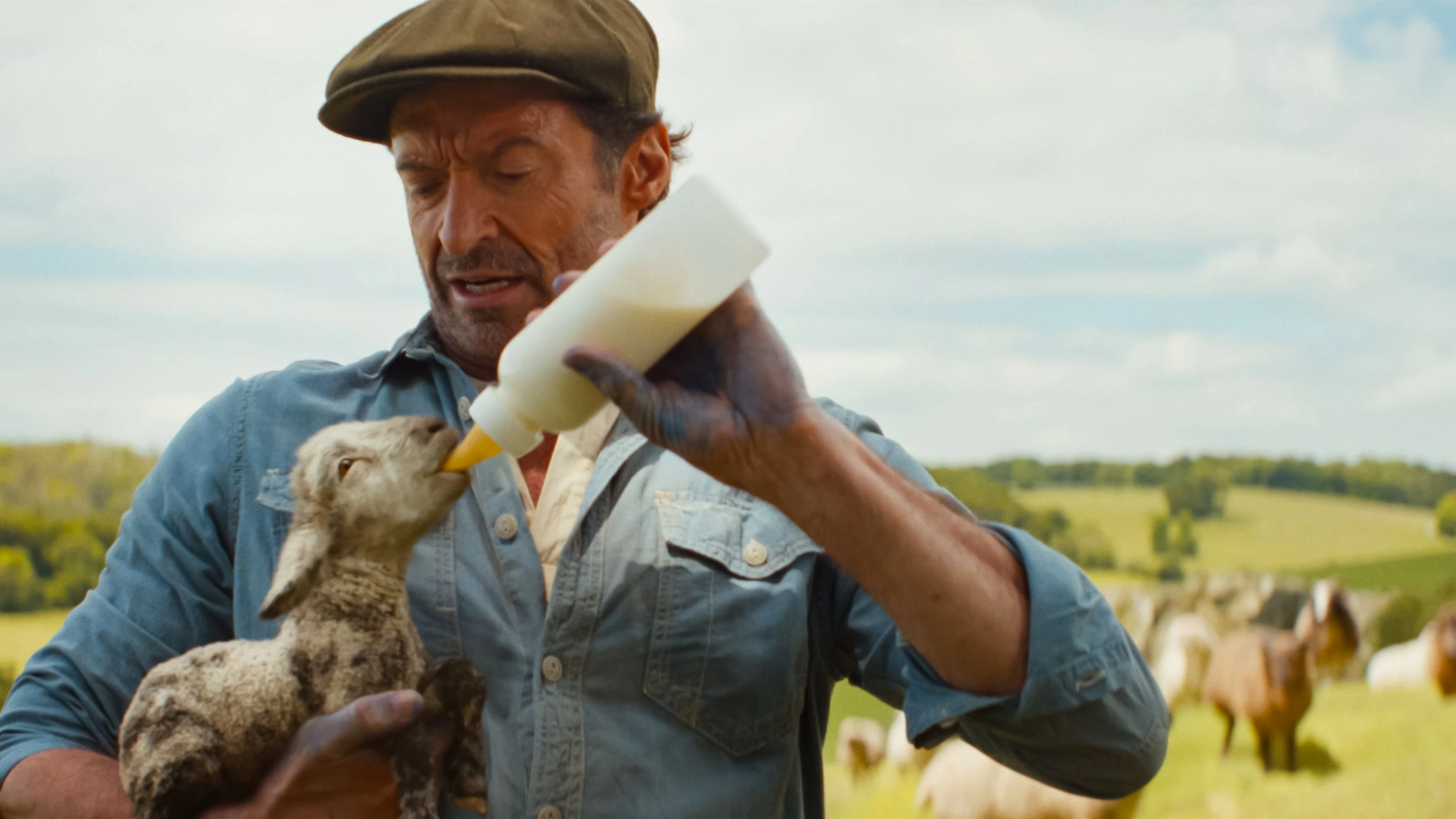 (L to R) Tommy Birchall as the voice of The Winter Lamb and Hugh Jackman as George Hardy in THE SHEEP DETECTIVES, from Amazon MGM Studios. Photo credit: Courtesy of Amazon MGM Studios © 2026 Amazon Content Services LLC. All Rights Reserved.