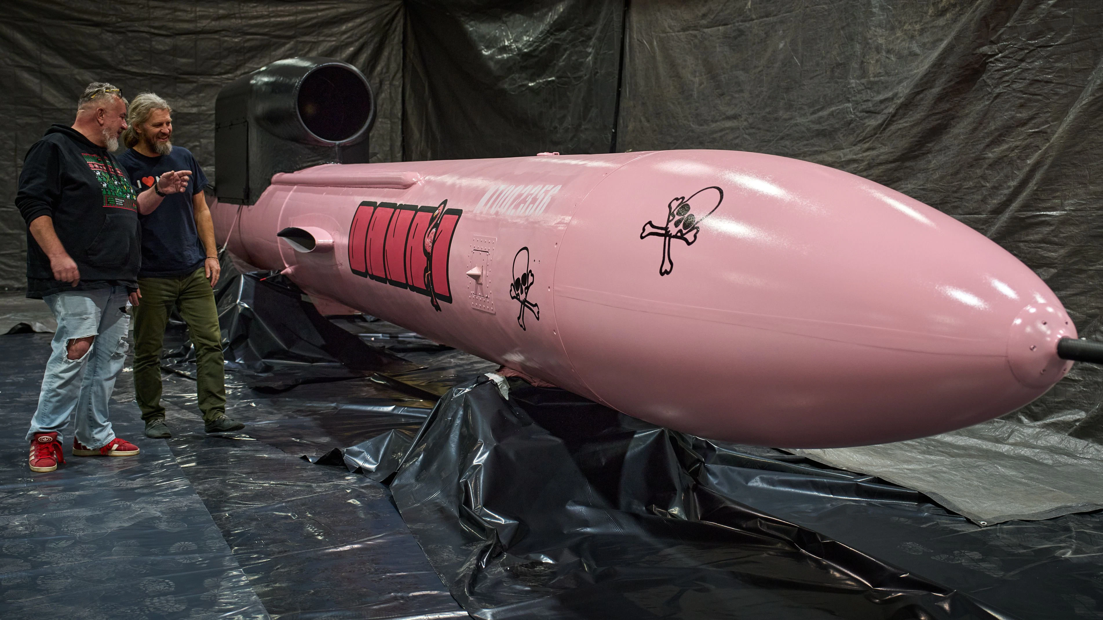 Jan Polak, right, and Martin Ondracek from the Czech organization, Weapons to Ukraine, look at a Flamingo cruise missile which was paid for by their crowdfunding campaign, at the Fire Point factory at an undisclosed location in Ukraine, Sunday, Nov. 16, 2025. (AP Photo/Efrem Lukatsky)