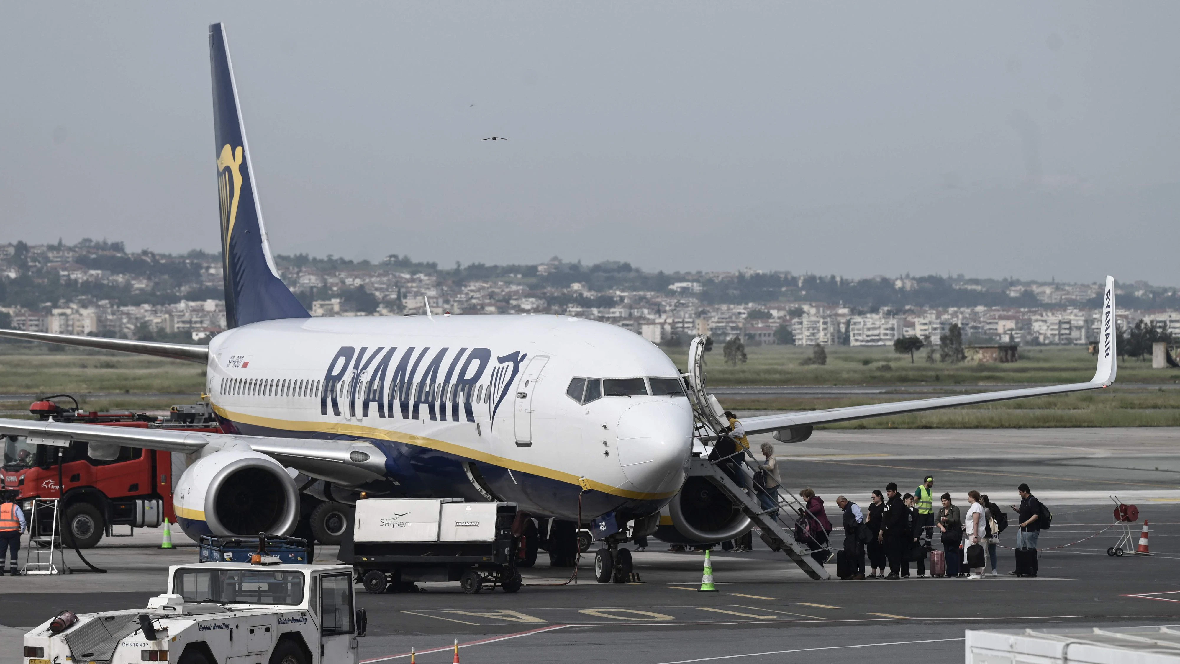 Passengers board an aircraft of low-cost Irish airline Ryanair at the Thessaloniki airport "Makedonia", in Thessaloniki on May 7, 2026. Ryanair will shut down its base at Thessaloniki Airport in October 2026, informing staff of the move. The decision follows a dispute over increased airport charges imposed by operator Fraport Greece. (Photo by Sakis Mitrolidis / AFP)