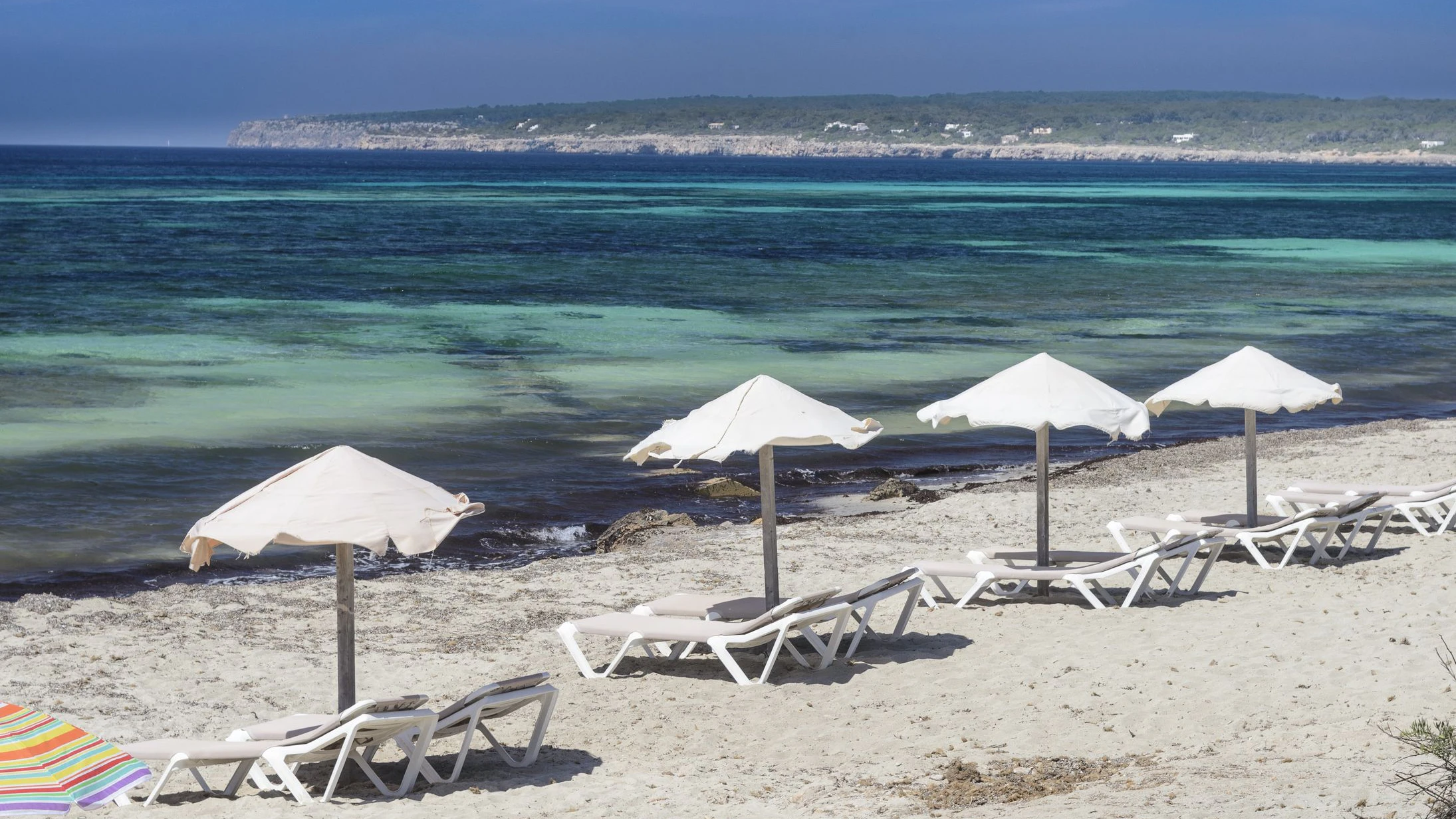 Turquoise water in a beach in the Island of Formentera, Pityusic Islands also named the Pine Islands, at Balearic Islands  small islets in the Mediterranean Sea; Spain