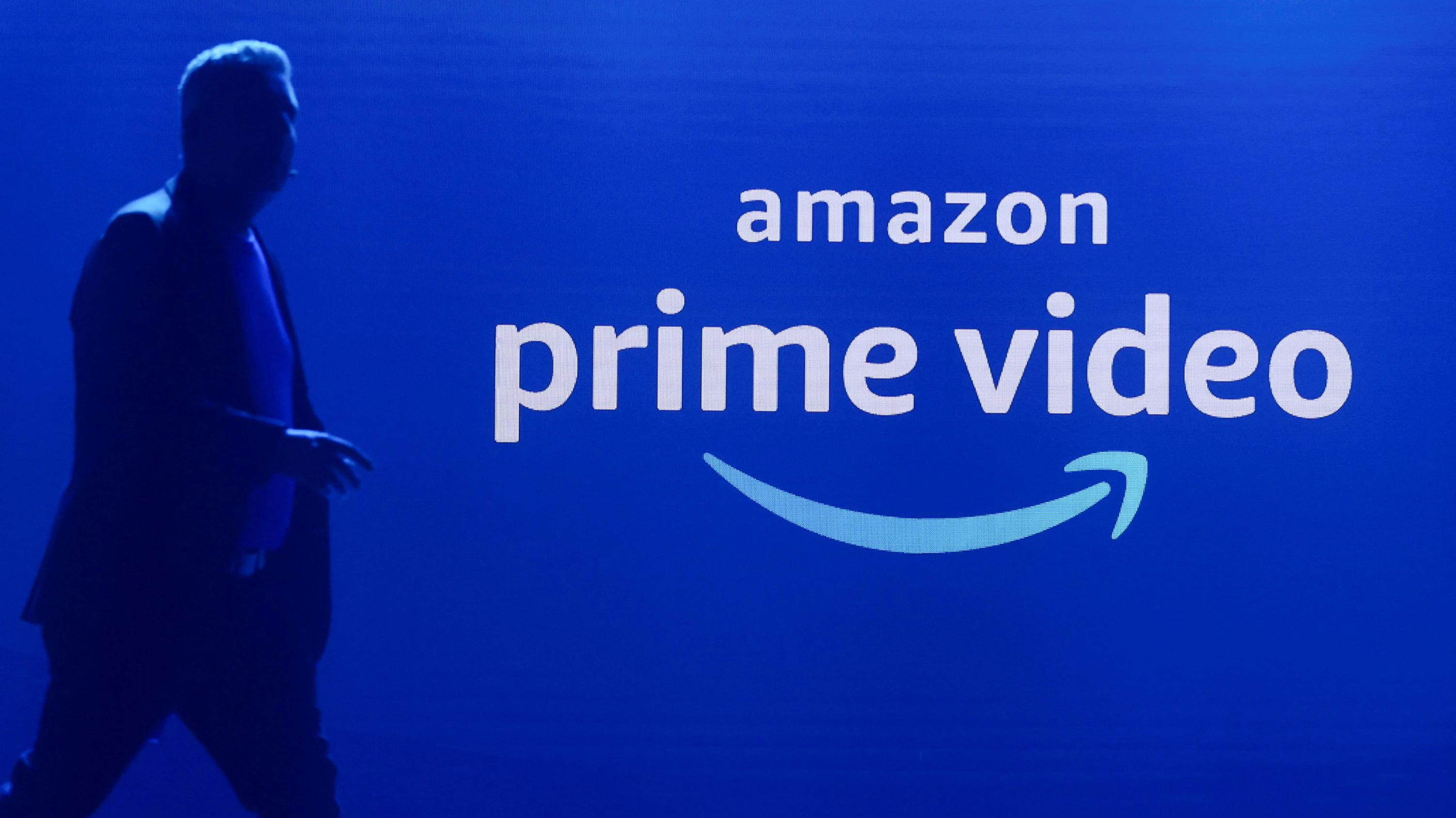 A man walks past a logo of Amazon Prime Video during a launch event in Mumbai, India, April 28, 2022. REUTERS/Francis Mascarenhas 