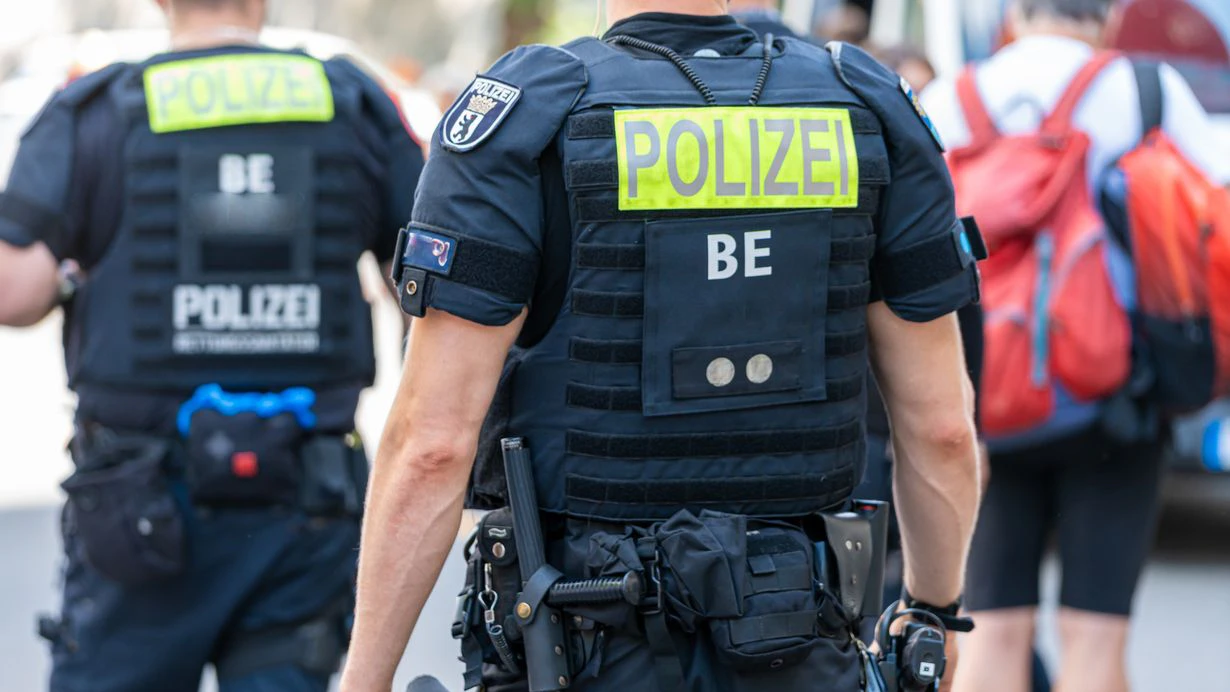 Germany, Berlin, Nollendorfplatz, Gay and Lesbians Festival, July 19, 2025 - Rear view of two police officers on duty on the street