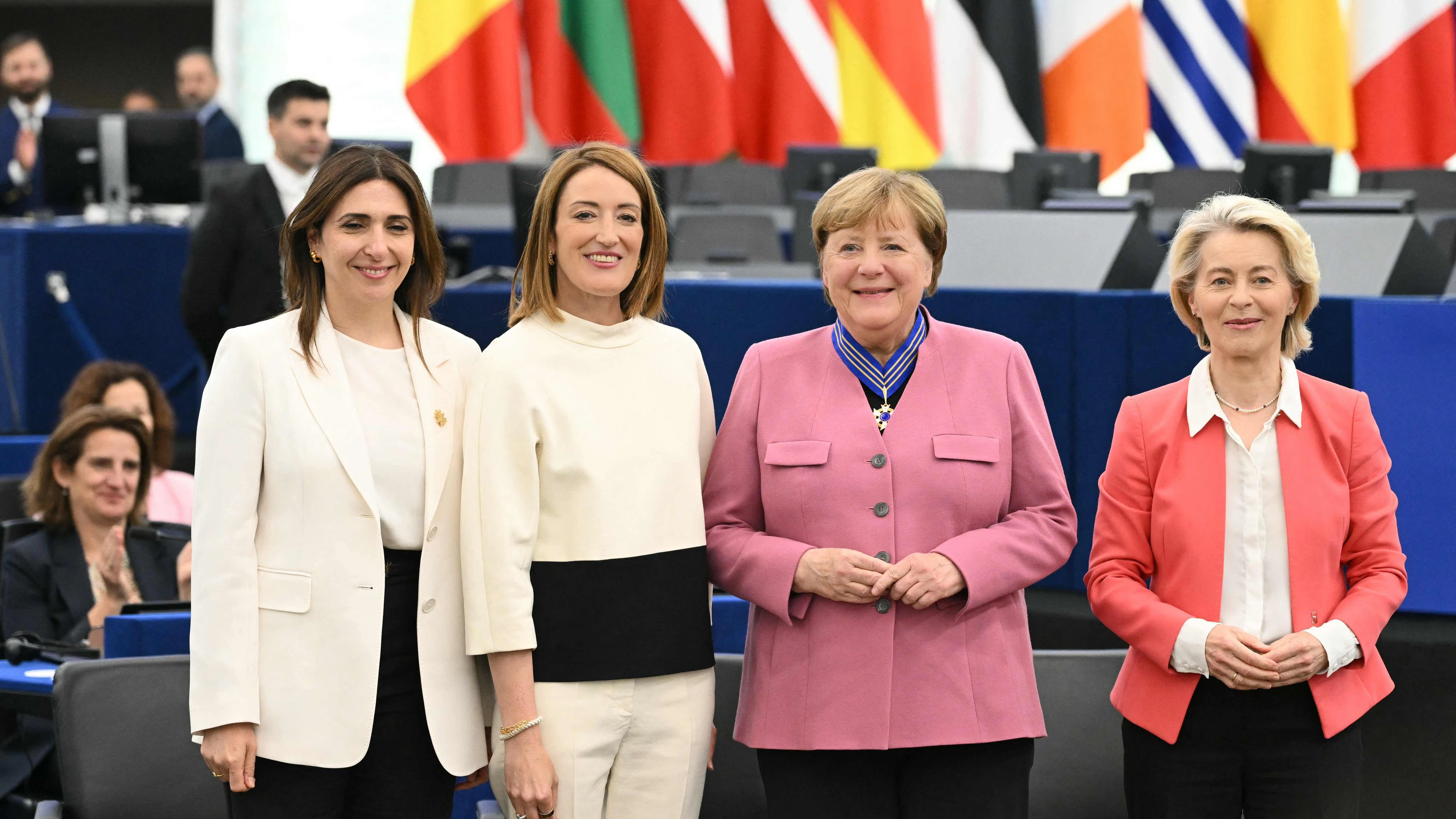 Former German Chancellor Angela Merkel (C-R) poses with Cyprus' Deputy Minister for European Affairs Marilena Raouna (L), European Parliament President Roberta Metsola (C-L) and European Commission President Ursula von der Leyen (R) after receiving the European Order of Merit during a ceremony to honour individuals who have made significant contributions to the European unity, democracy or to the promotion and defence of European values at the European Parliament's hemicycle in Strasbourg, eastern France on May 19, 2026. The European Parliament established the first European distinction of its kind — the European Order of Merit — in 2025 to mark the 75th anniversary of the Schuman Declaration, with the inaugural ceremony taking place in 2026. (Photo by SEBASTIEN BOZON / AFP)