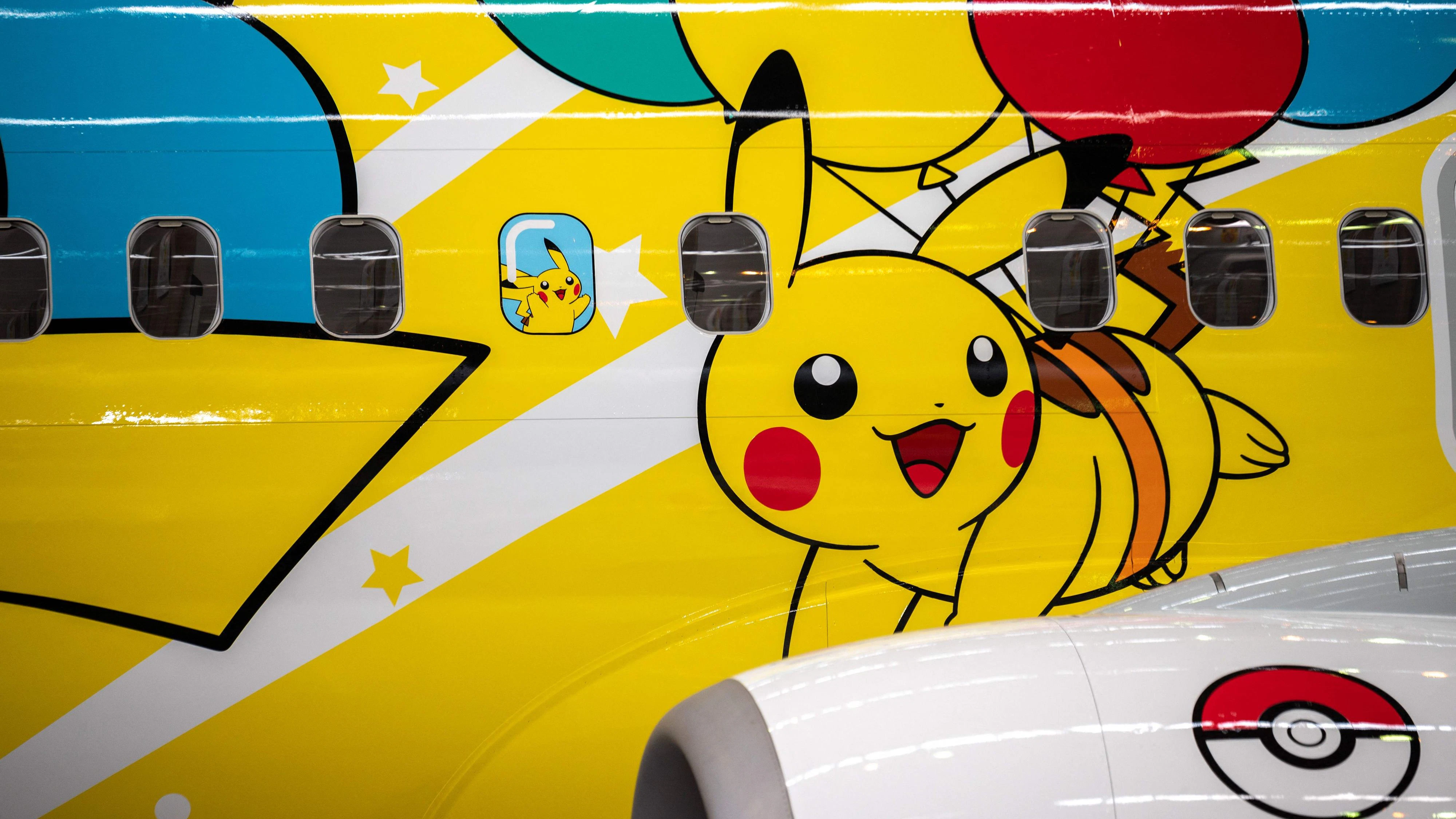A Skymark Airlines Boeing 737-800 aircraft with new Pokemon-themed livery is seen in a hangar during its unveiling at Tokyo's Haneda international airport on June 21, 2021. (Photo by Charly TRIBALLEAU / AFP)