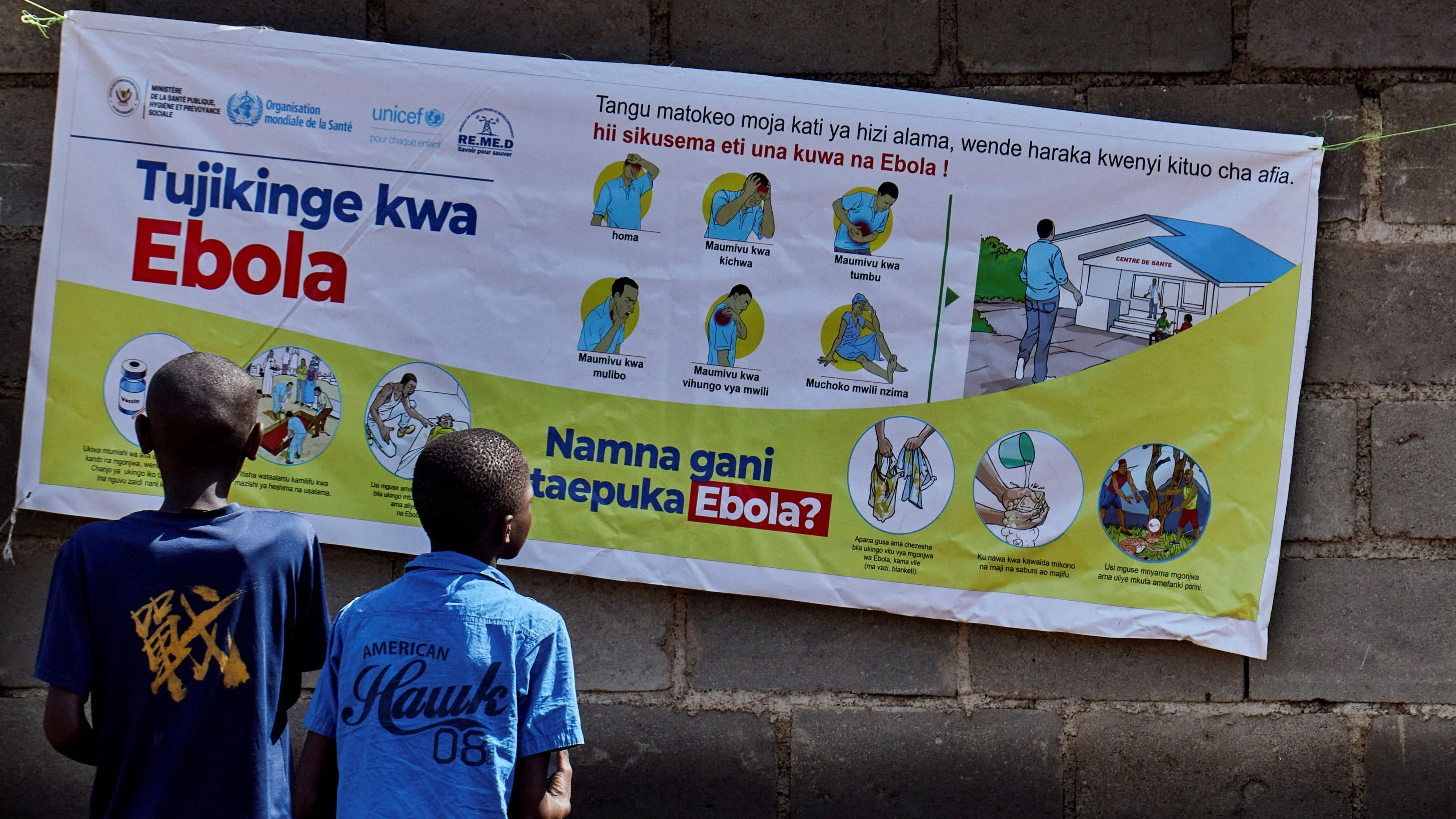 Congolese children Ibrah Asimwe and Alex Uketi read an advocacy poster as aid agencies intensify efforts to contain a new Ebola outbreak involving the Bundibugyo strain outbreak, in Bunia, Ituri province, Democratic Republic of Congo, May 20, 2026. REUTERS/Gradel Muyisa Mumbere/