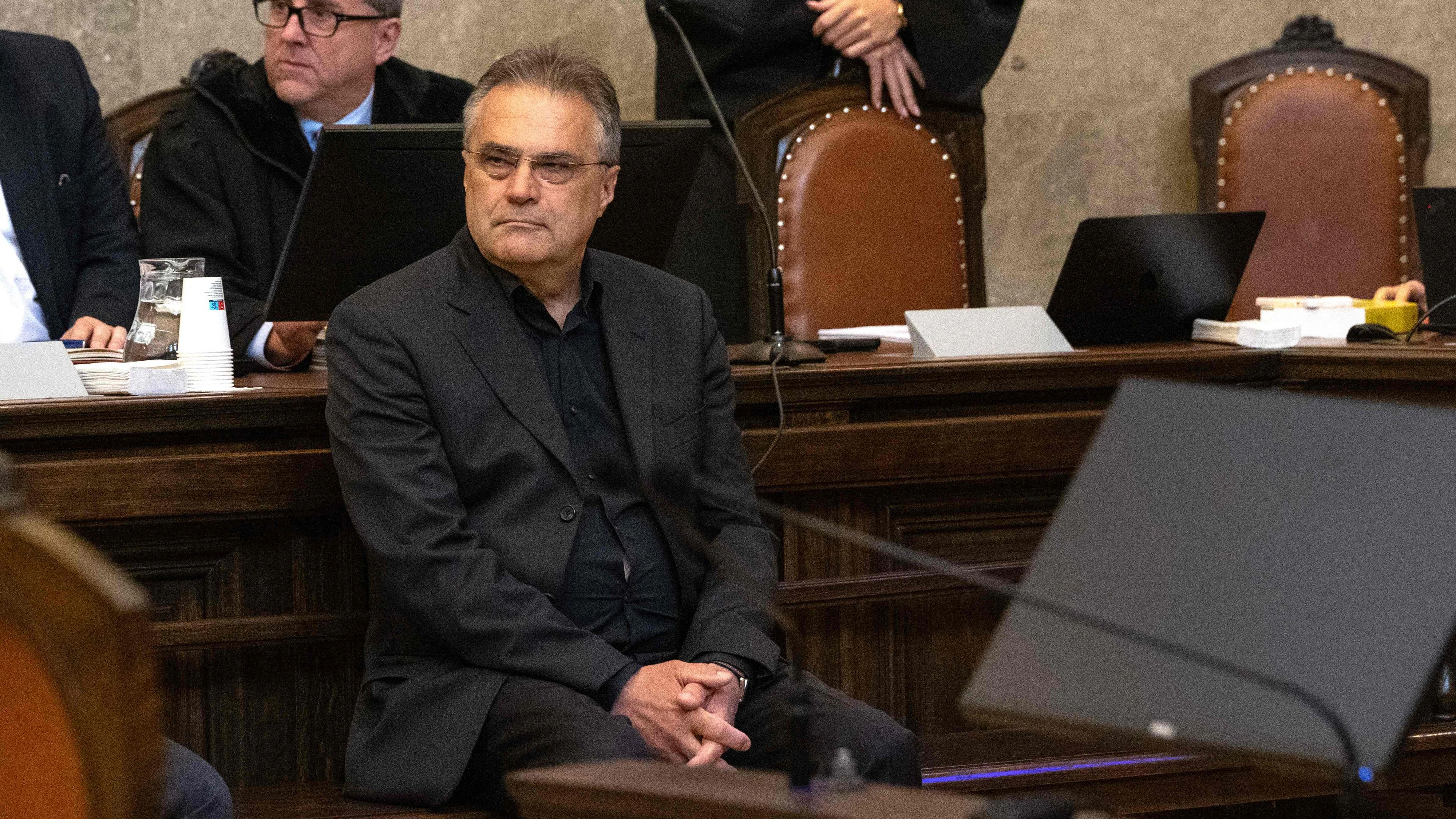 Austrian former intelligence official Egisto Ott (sitting in foreground) has taken his seat to attend a session of his trial at the criminal court in Vienna, Austria, where the verdict was expected on May 20, 2026. Ott is currently standing trial on a slew of charges that include handing over sensitive devices and selling secret information to Russia. Ott, who denies all the charges against him, is also accused of having passed secret information for years to Jan Marsalek, the former chief operating officer of Germany's collapsed payment processing firm Wirecard, who is suspected of working for Russia's intelligence services. (Photo by Joe Klamar / AFP)