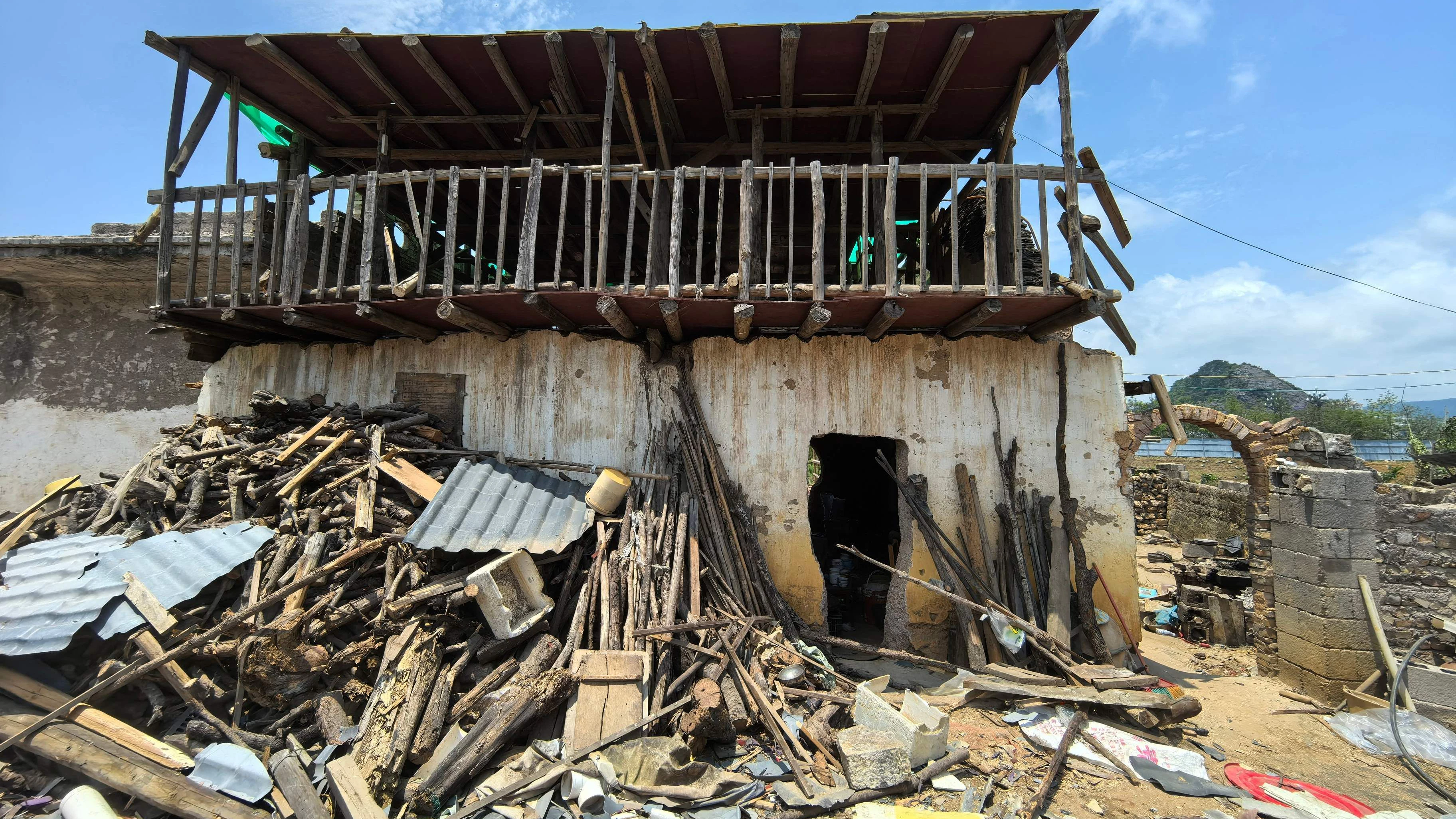 *** HANDOUT *** This handout photo taken and released by Chen Tianming on May 21, 2026 shows the remains of a house built by Chen Tianming after authorities knocked down the upper floors of the 10-storey home in Xingyi, in China's southwest Guizhou province. Authorities have razed a ramshackle 10-storey home that for years defied demolition notices and building restrictions to become an off-beat tourist attraction in southwestern China, footage from the owner showed. (Photo by Handout / Chen Tianming / AFP) / -----EDITORS NOTE --- RESTRICTED TO EDITORIAL USE - MANDATORY CREDIT "AFP PHOTO / Chen Tianming " - NO MARKETING - NO ADVERTISING CAMPAIGNS - DISTRIBUTED AS A SERVICE TO CLIENTS