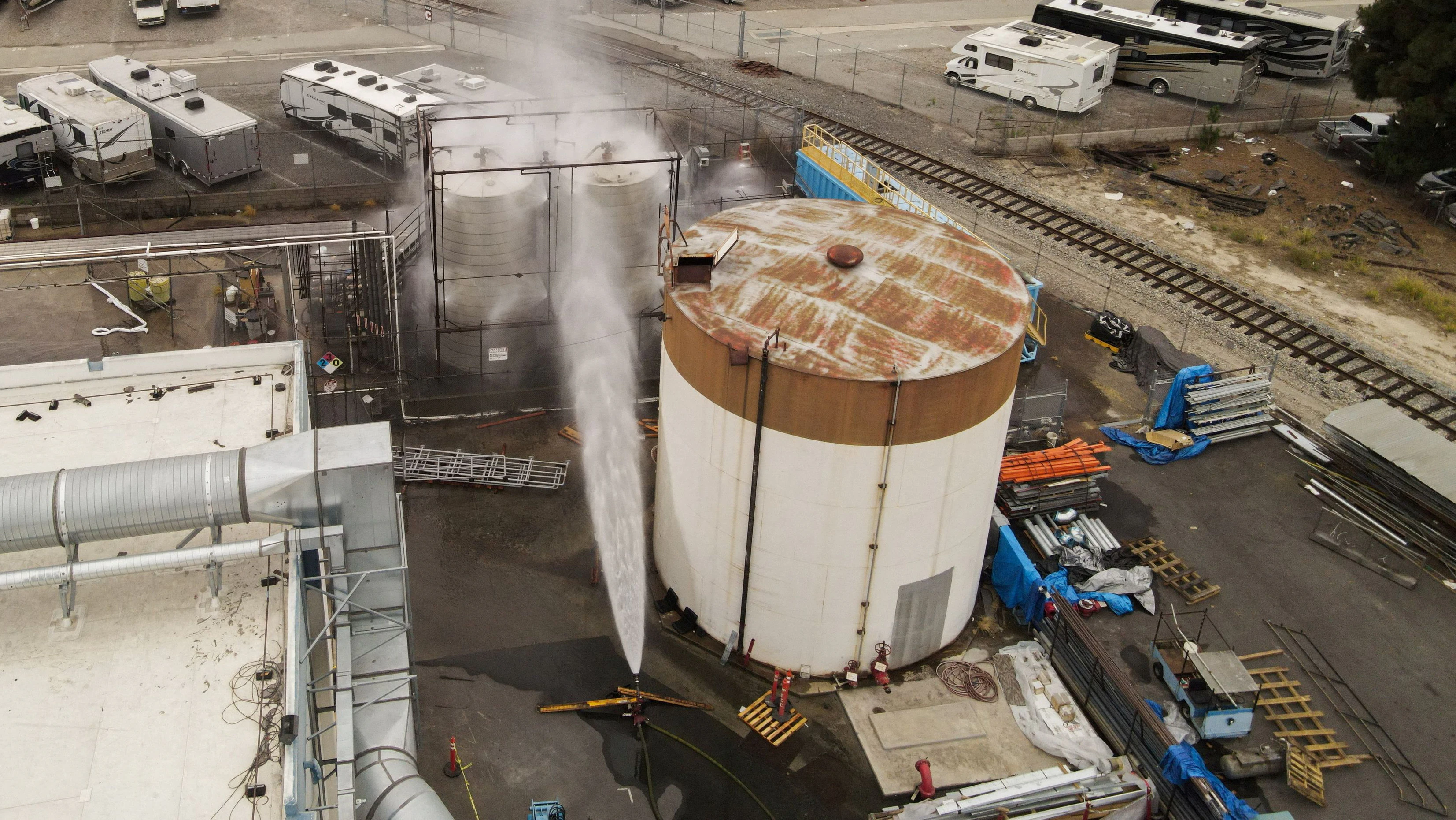 A drone view shows water being sprayed during a chemical incident involving a leaking tank of methyl methacrylate, a flammable liquid used in the aerospace industry, forcing an evacuation in the surrounding area, in Garden Grove, California, U.S., May 23, 2026. REUTERS/David Swanson     TPX IMAGES OF THE DAY     