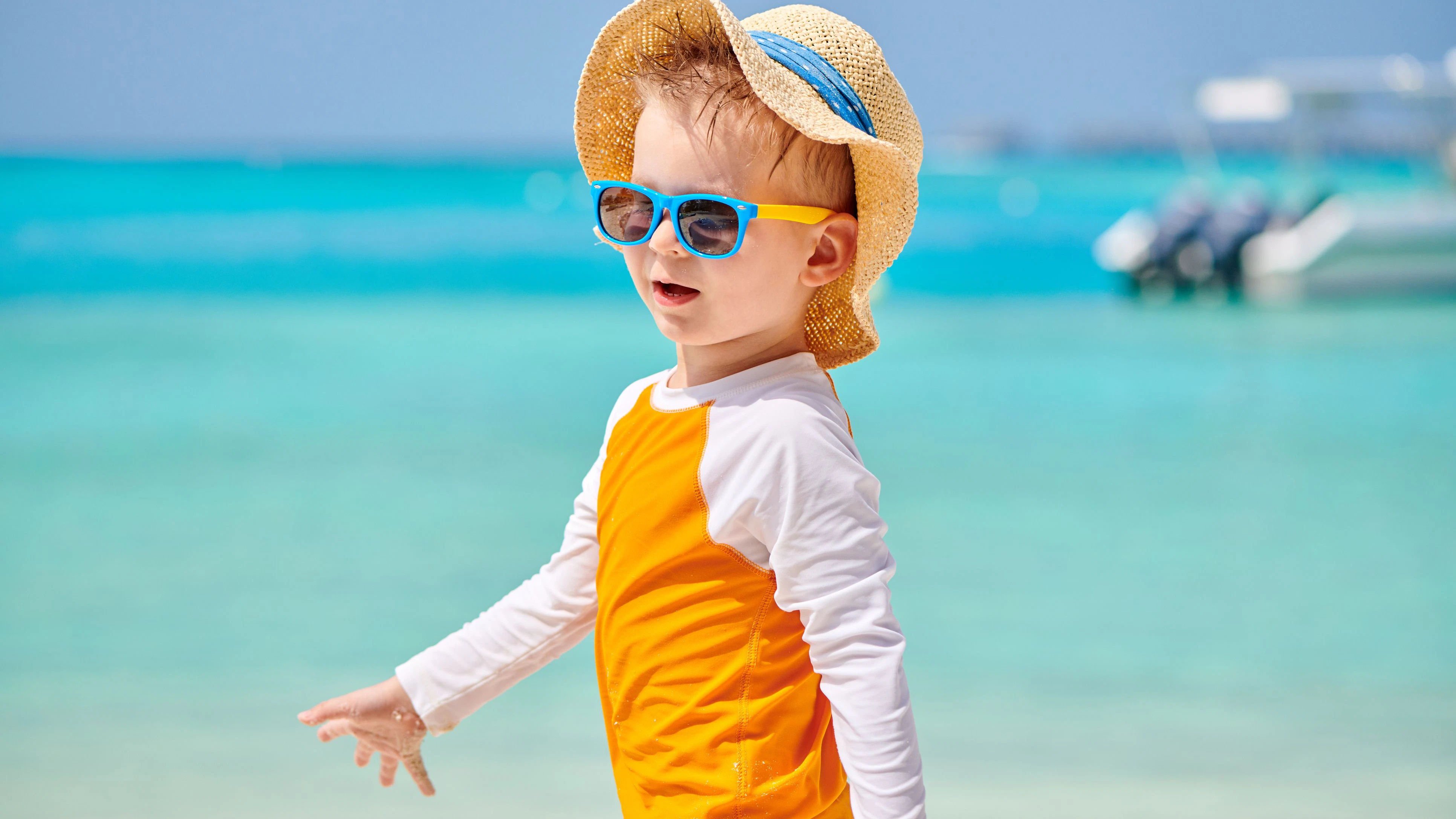 Three year old toddler boy on beach. Summer family vacation at Maldives.