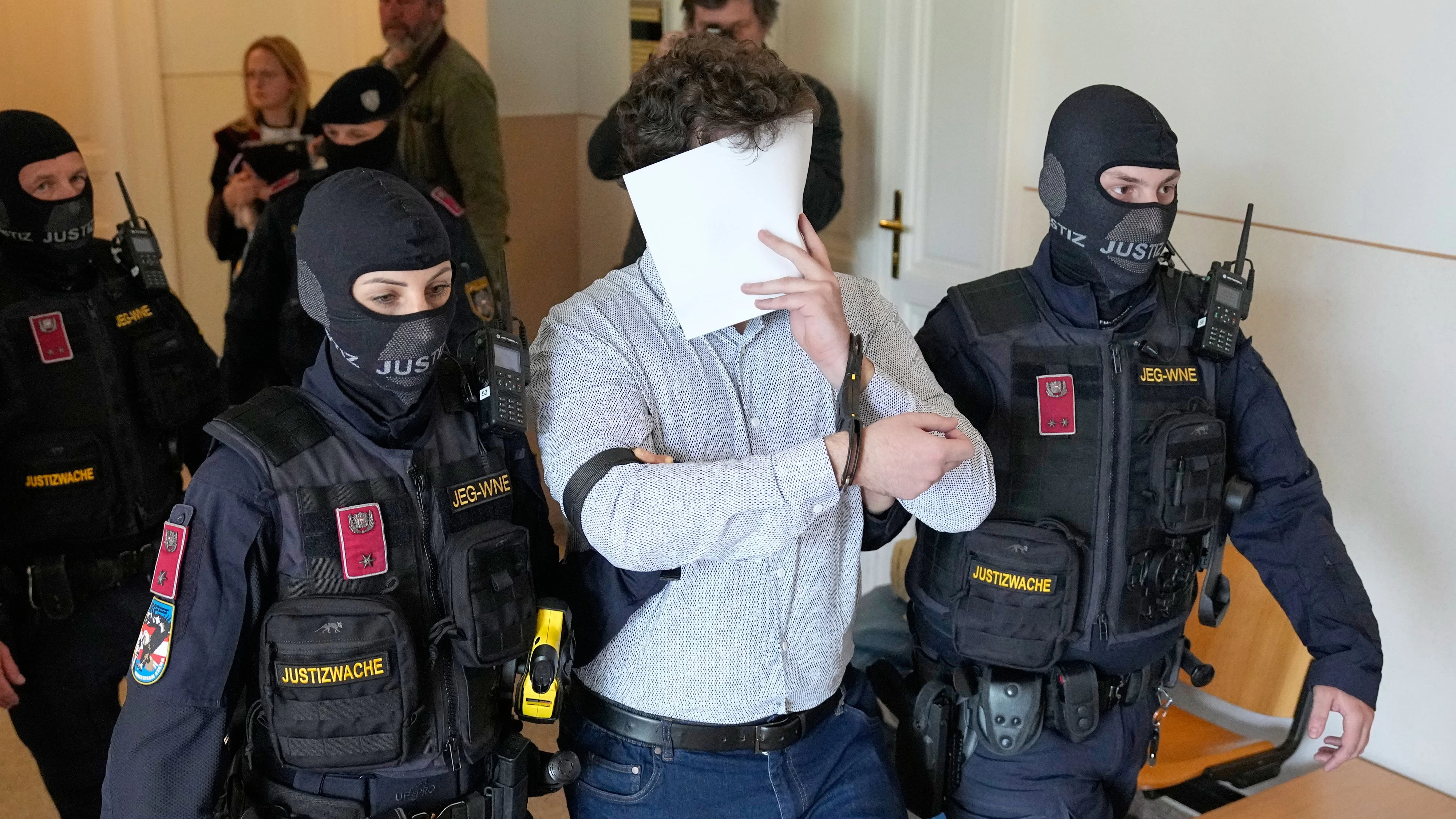 FILE - Defendant Beran A. is returned to the courtroom in the District Court in Wiener Neustadt, Austria, where he stands trial for plotting to carry out an attack on one of superstar singer Taylor Swift's concerts in Vienna in August 2024 and pledging allegiance to the Islamic State group, April 28, 2026. (AP Photo/Matthias Schrader, File)