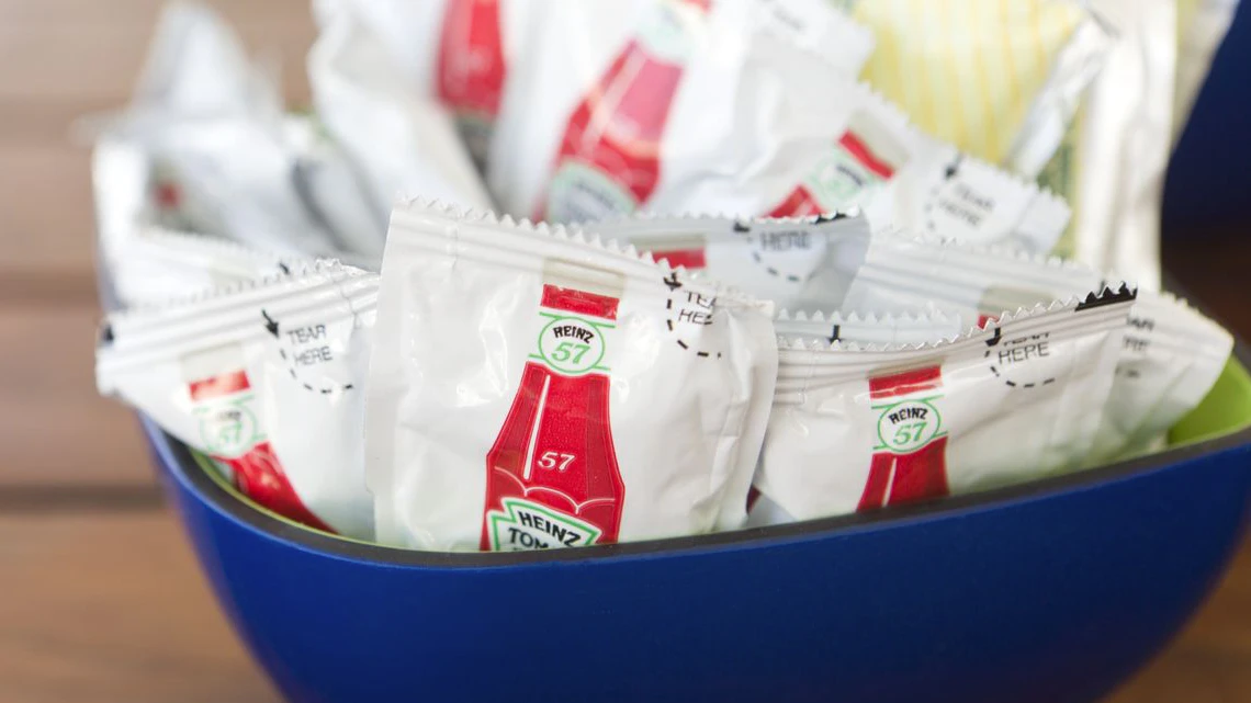 "Nassau, Bahamas - March 28, 2012: Bowl containing condiment packets of Heinz 57 ketchup on restaurant table."
