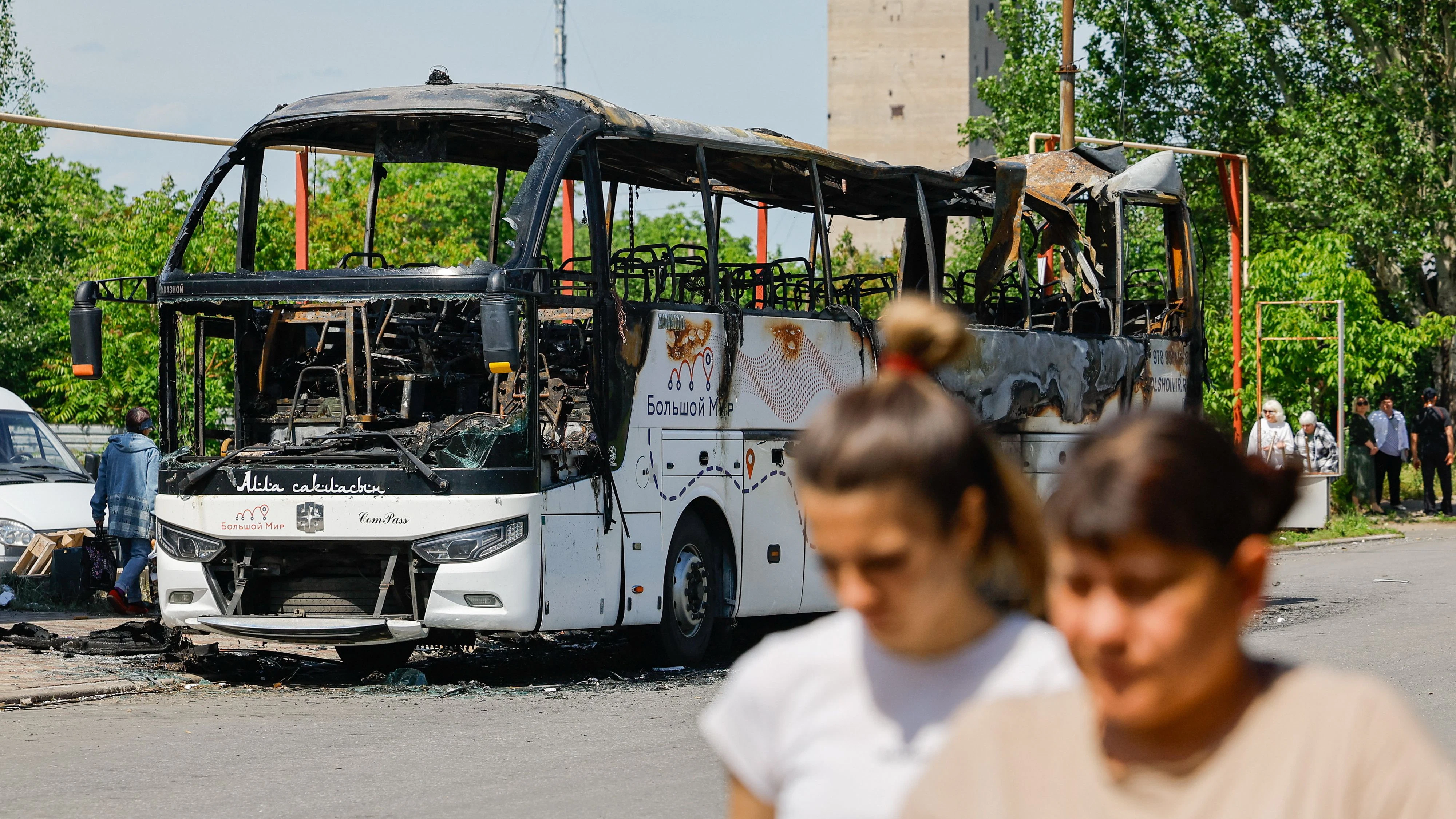 People walk near the site of a Ukrainian drone attack on a bus, according to local authorities in the course of the Russia-Ukraine military conflict, in the settlement of Yenakiievo in the Donetsk region, a Russian-controlled part of Ukraine, June 3, 2026.  REUTERS/Alexander Ermochenko  
