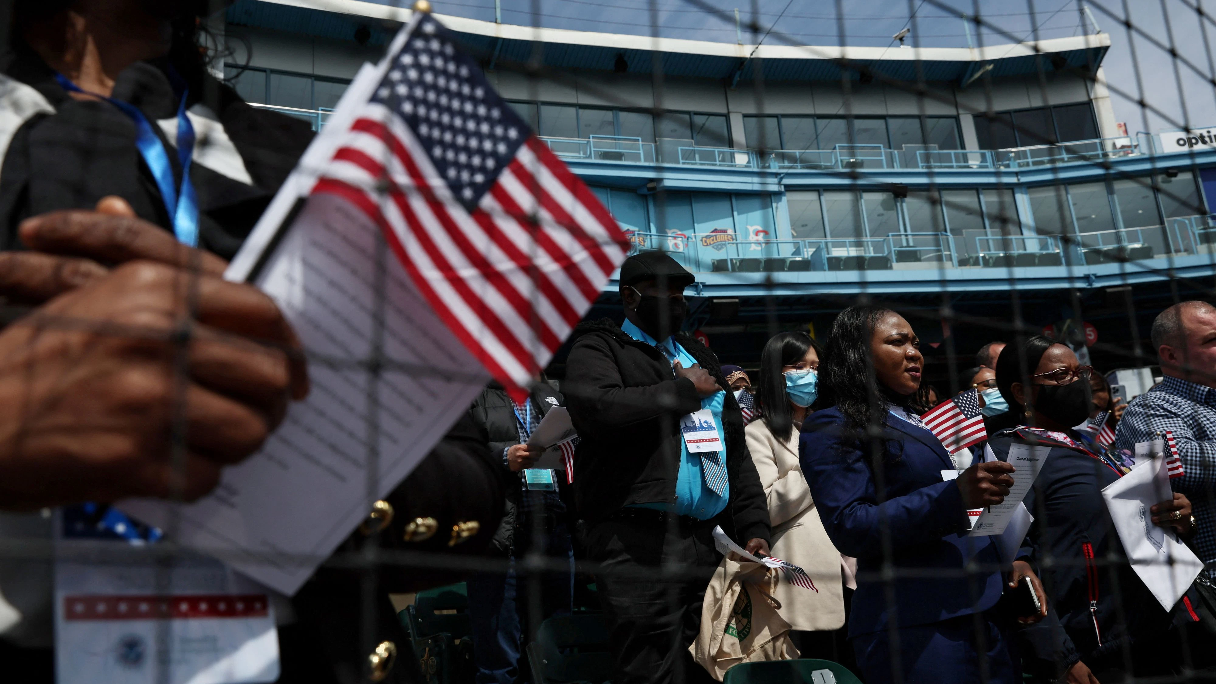 FILE PHOTO: Citizen candidates attend a U.S. Citizenship and Immigration Services (USCIS) naturalization ceremony at the Brooklyn Cyclones Maimonides Park in the Brooklyn borough of New York City, U.S. May 3, 2022.  REUTERS/Shannon Stapleton/File Photo