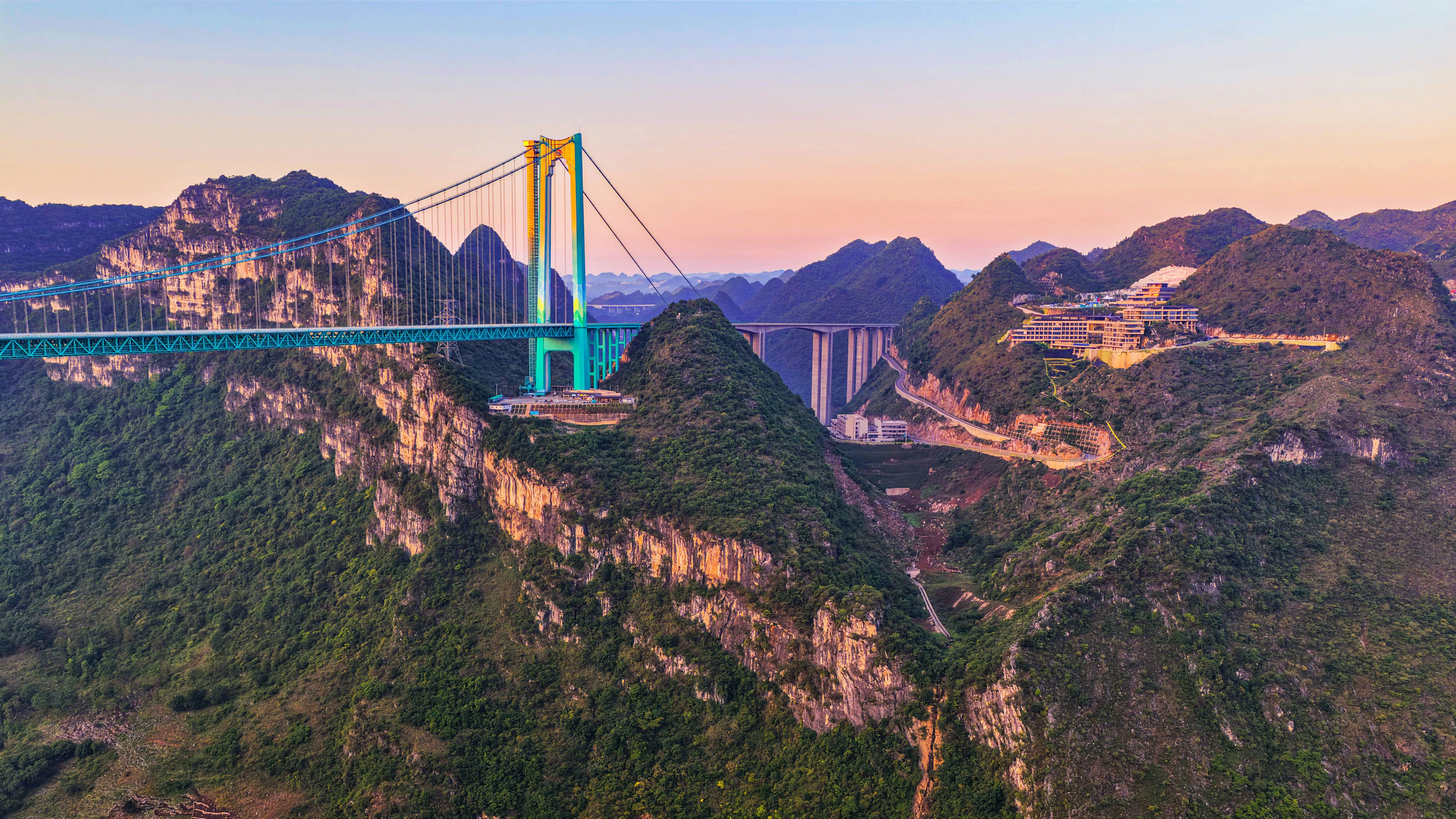 ANSHUN, CHINA - MAY 04: Aerial view of the Huajiang Grand Canyon Bridge illuminated by morning glow during the May Day holiday on May 4, 2026 in Anshun, Guizhou Province of China. Located on the Liuzhi-Anlong Expressway in southwest China s Guizhou Province, the bridge stretches 2,890 meters in total length, with a main span of 1,420 meters and a height of 625 meters above the water. PUBLICATIONxNOTxINxCHN Copyright: xVCGx 111639697844