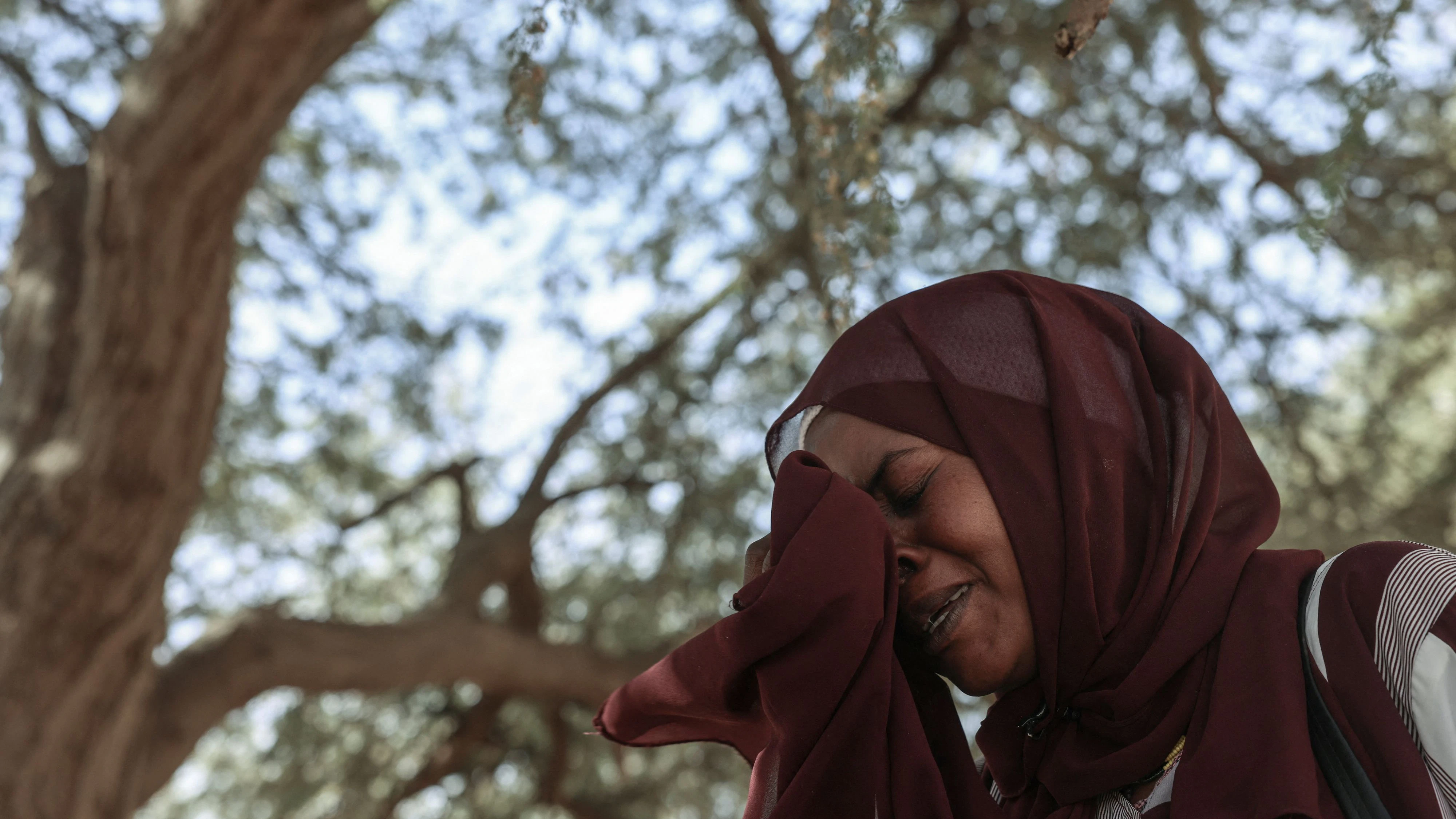 Mona Mohamed, 33, a Sudanese refugee who fled Al-Fashir, reacts during an interview with Reuters, amid ongoing conflict in Sudan between the paramilitary Rapid Support Forces (RSF) and the Sudanese army, at the Iridimi refugee camp, northwest of the town of Iriba, in Wadi Fira province, eastern Chad, November 27, 2025. REUTERS/Amr Abdallah Dalsh TPX IMAGES OF THE DAY  SEARCH "ABDALLAH DALSH SUDAN SURVIVORS" FOR THIS STORY. SEARCH "WIDER IMAGE" FOR ALL STORIES.  