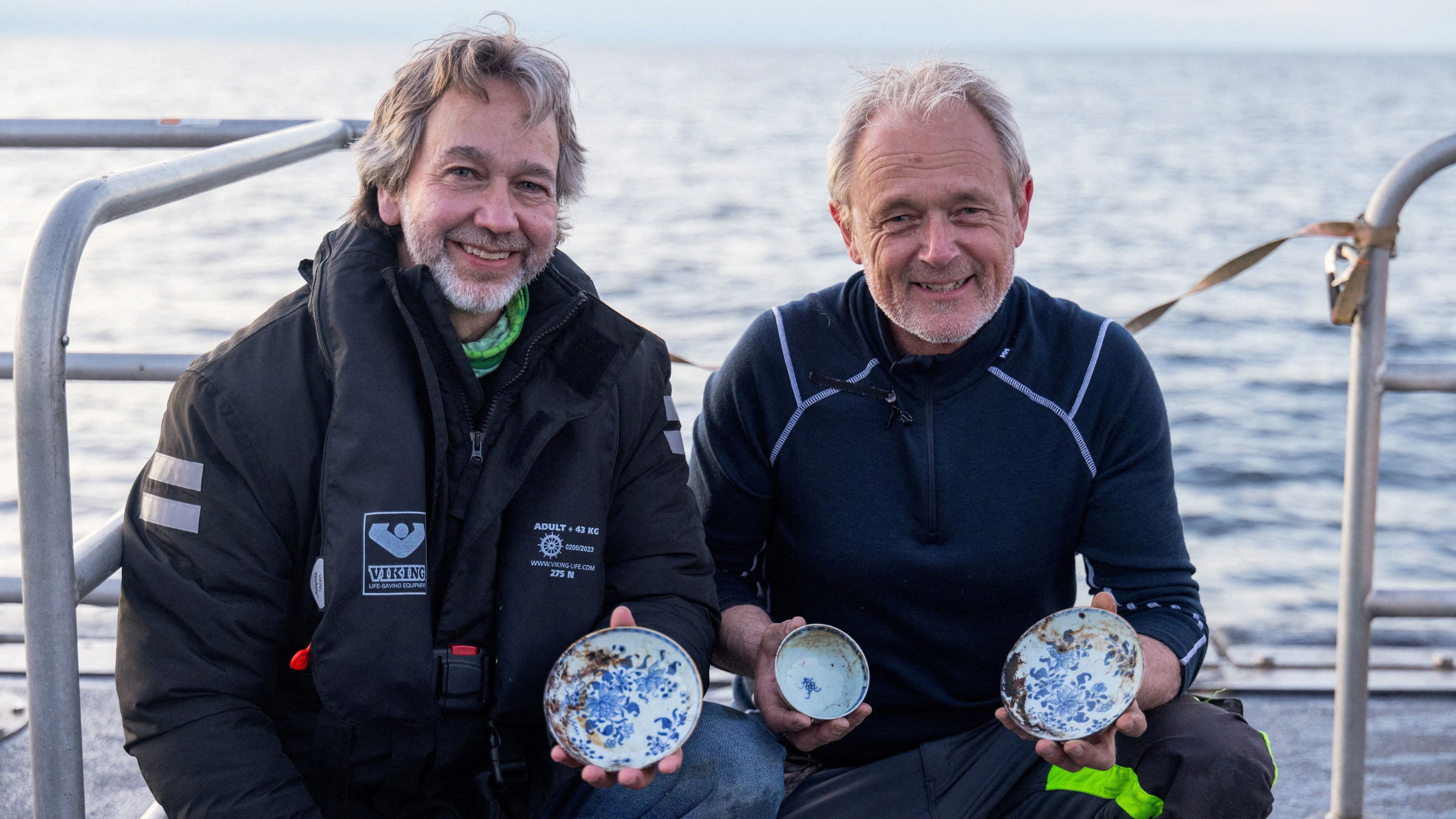 Crew members pose with a trove of Chinese porcelain from a recently discovered 18th-century shipwreck off the coast of Norway, at the Skagerrak Sea in this undated handout picture. Sindre Kinnerod/Flash Studio/Handout via REUTERS THIS IMAGE HAS BEEN SUPPLIED BY A THIRD PARTY. MANDATORY CREDIT.     